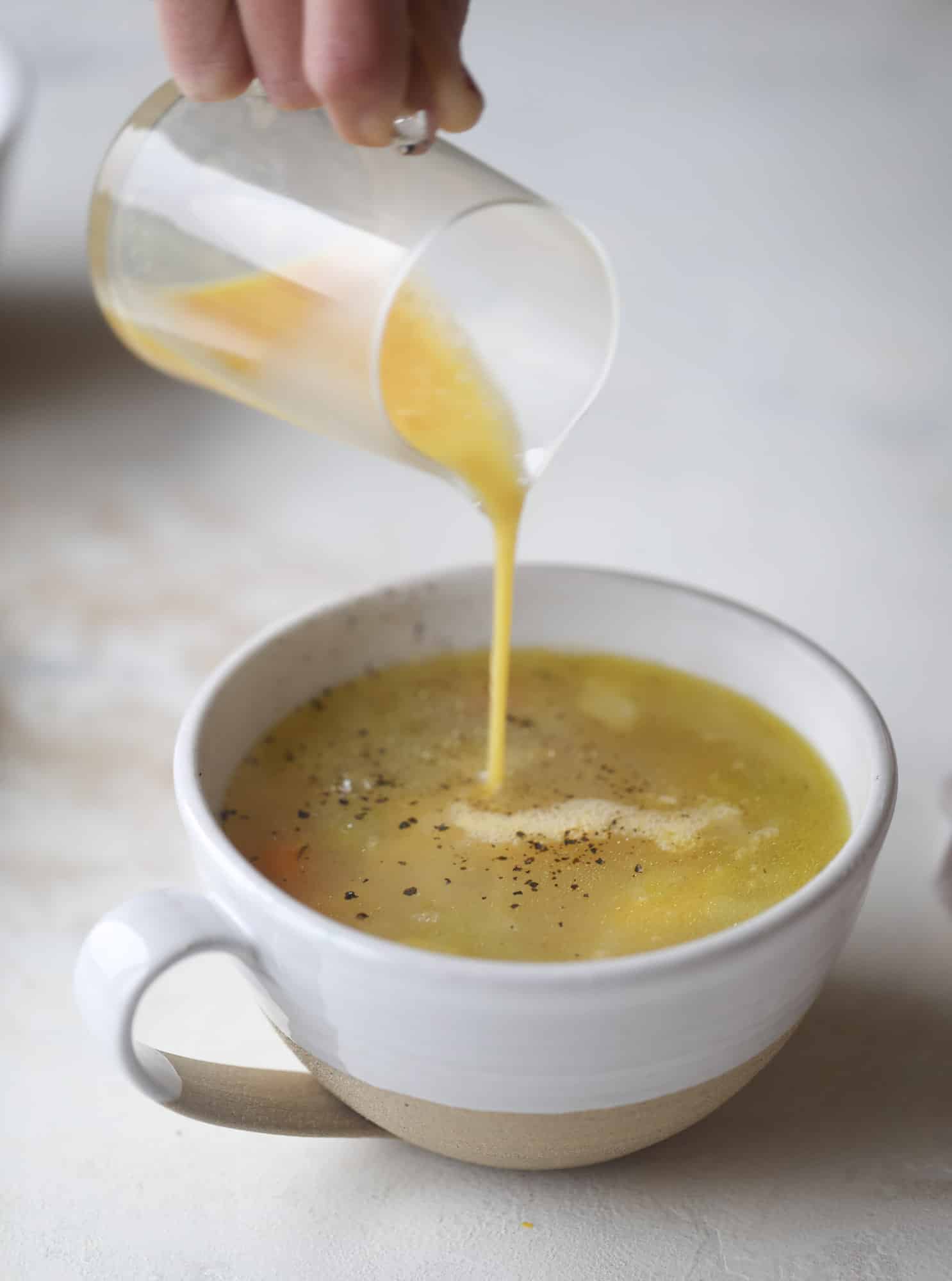 This chicken noodle egg drop soup is the ultimate comfort food! Homemade stock and satisfying ingredients provide the best nourishment and comfort! I howsweeteats.com #chicken #noodlesoup