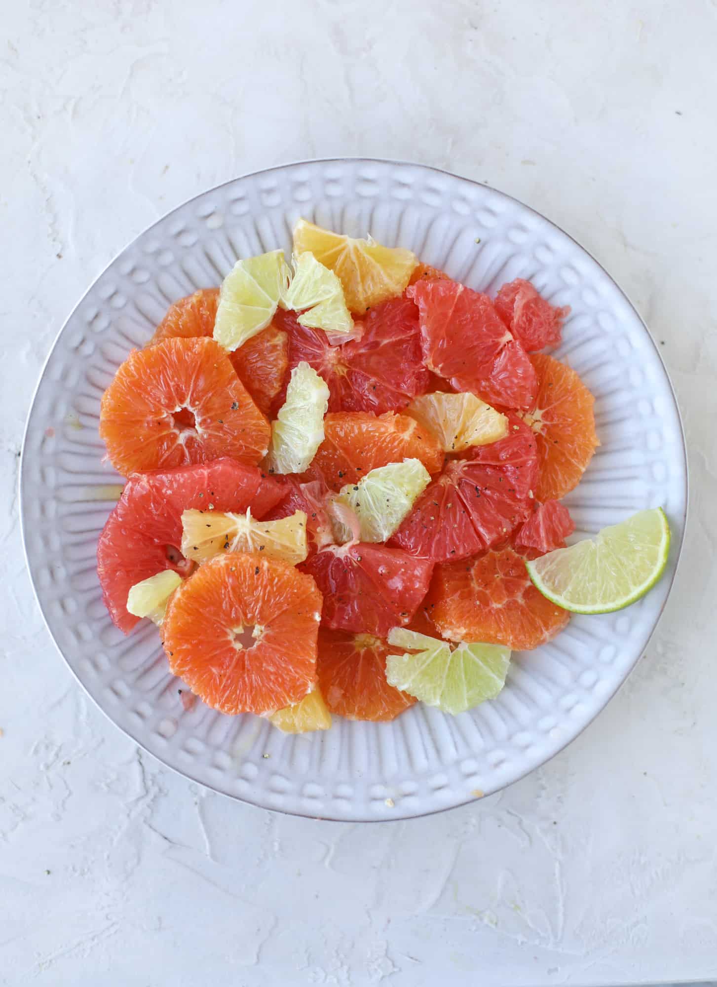 A deliciously fresh and invigorating avocado citrus salad with honey lime vinaigrette. It's creamy, tart, sweet and refreshing! I howsweeteats.com #avocado #citrussalad