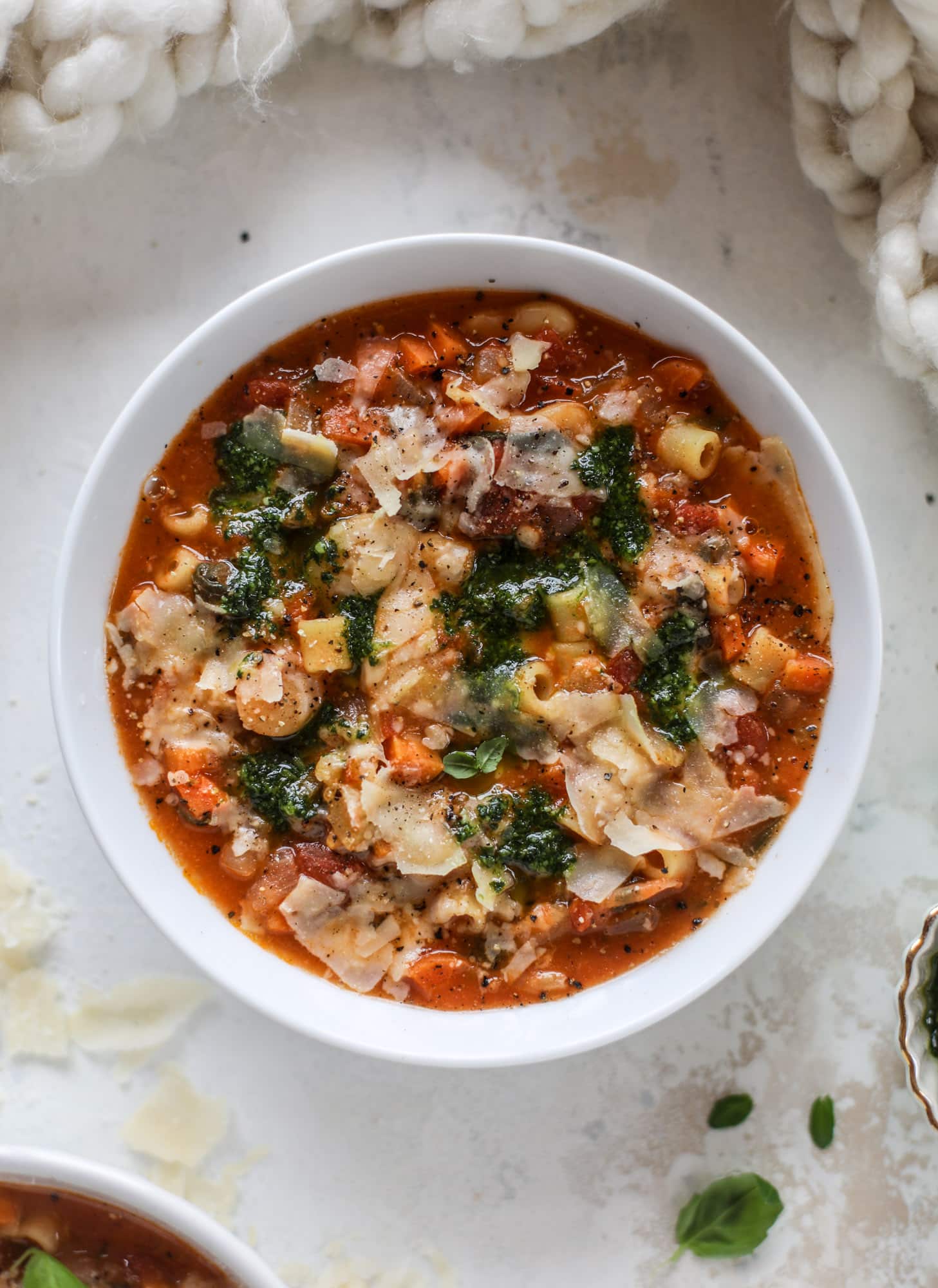 This fire roasted minestrone soup is like a huge in a bowl. Chock full of vegetables, fire roasted tomatoes and butter beans, the bowl is topped off with a delicious kale pesto that adds even more flavor. Satisfying, healthy and perfect for dinner! I howsweeteats.com #minestrone #soup