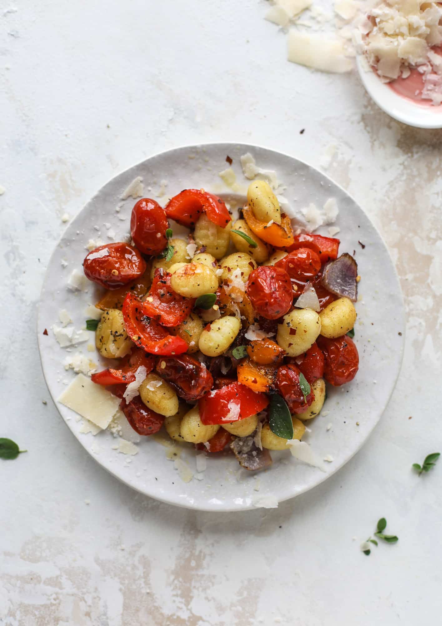Sheet pan gnocchi is an easy meal that the whole family will love! Toasted gnocchi along with burst tomatoes and caramelized peppers makes the best dinner. I howsweeteats.com #sheetpan #gnocchi