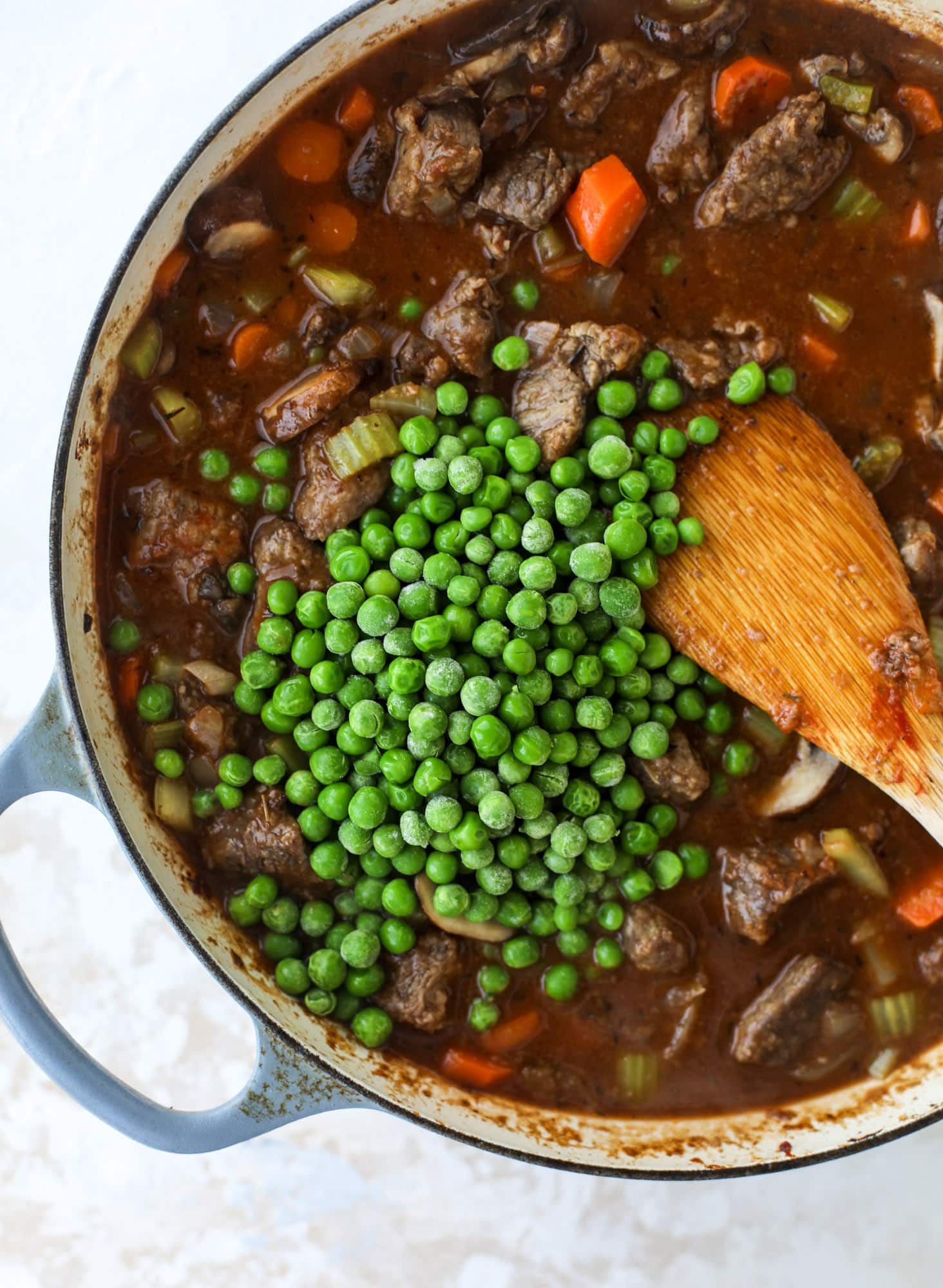 A perfect cold weather comfort food meal, Guiness pot pie has tender, fall-apart beef, lots of vegetables and is topped with buttery beer bread biscuits! I howsweeteats.com #guinness #potpie