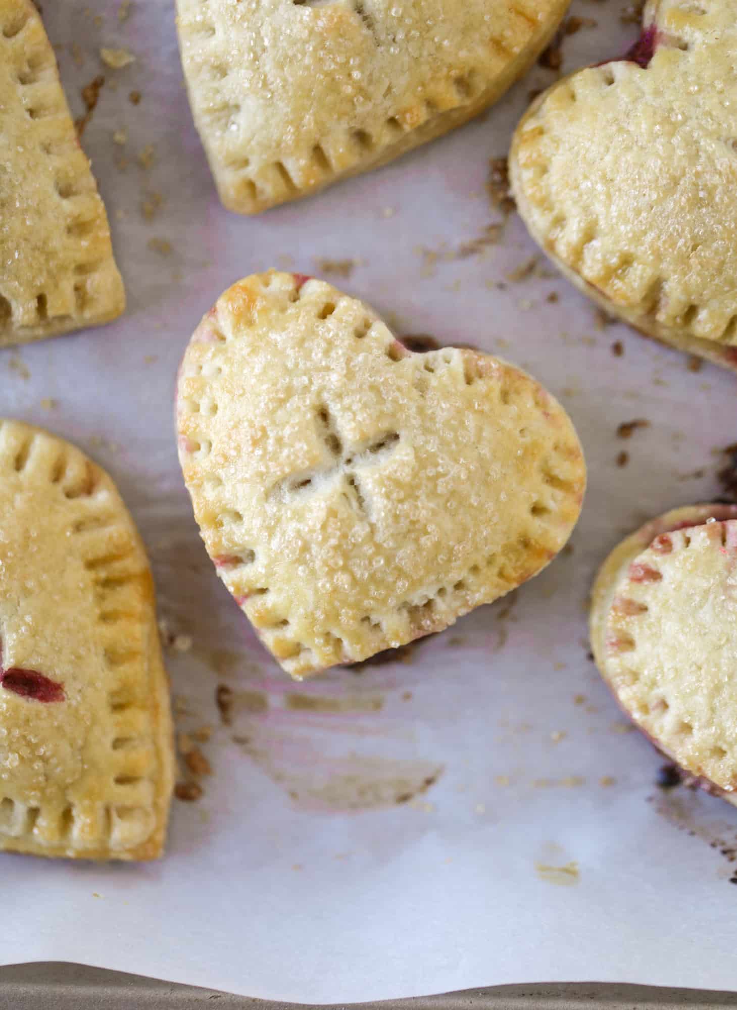 These adorable mini heart pies are filled with a homemade raspberry compote and creamy, chocolatey nutella. So fun and easy to make! I howsweeteats.com #heart #pie