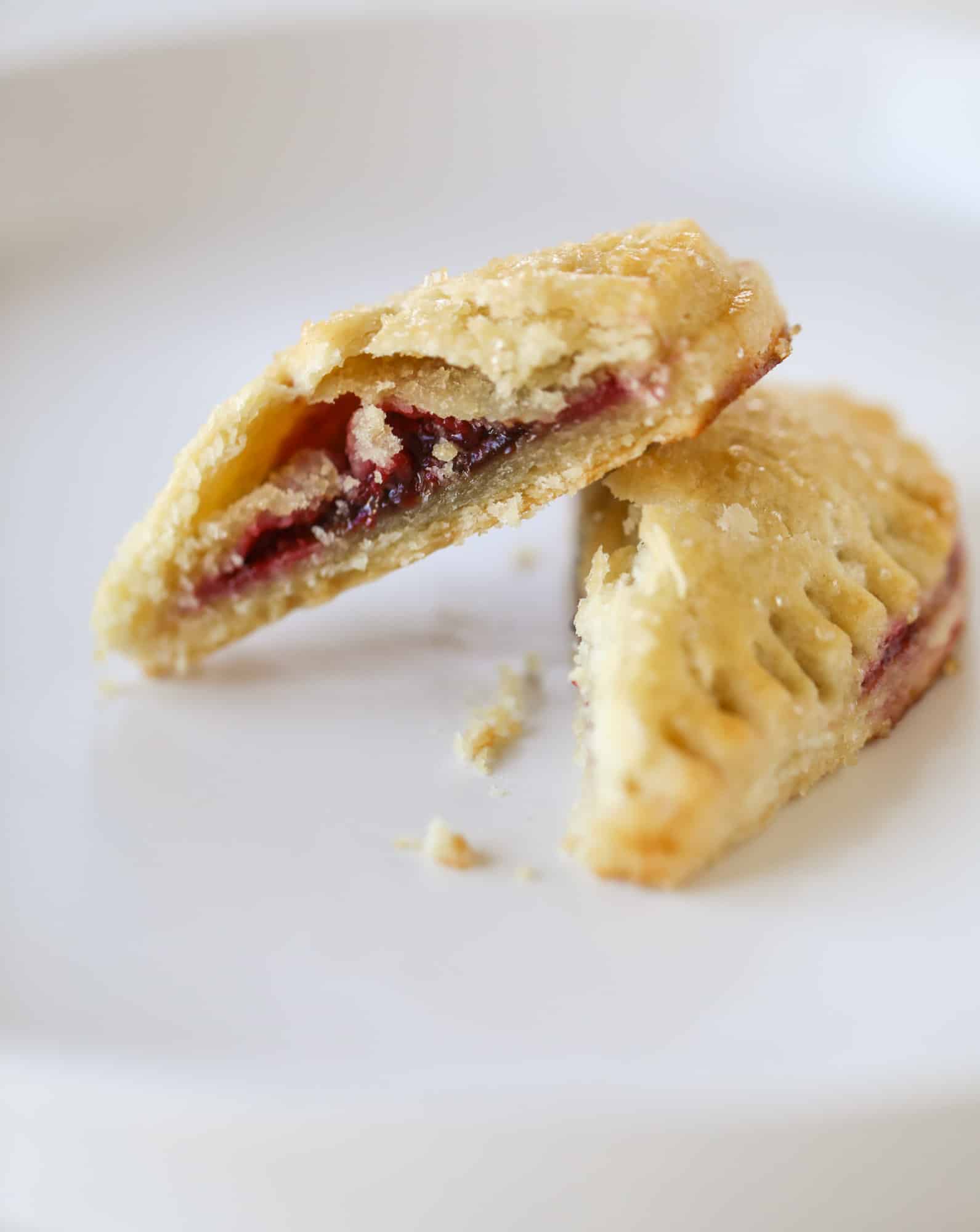 These adorable mini heart pies are filled with a homemade raspberry compote and creamy, chocolatey nutella. So fun and easy to make! I howsweeteats.com #heart #pie