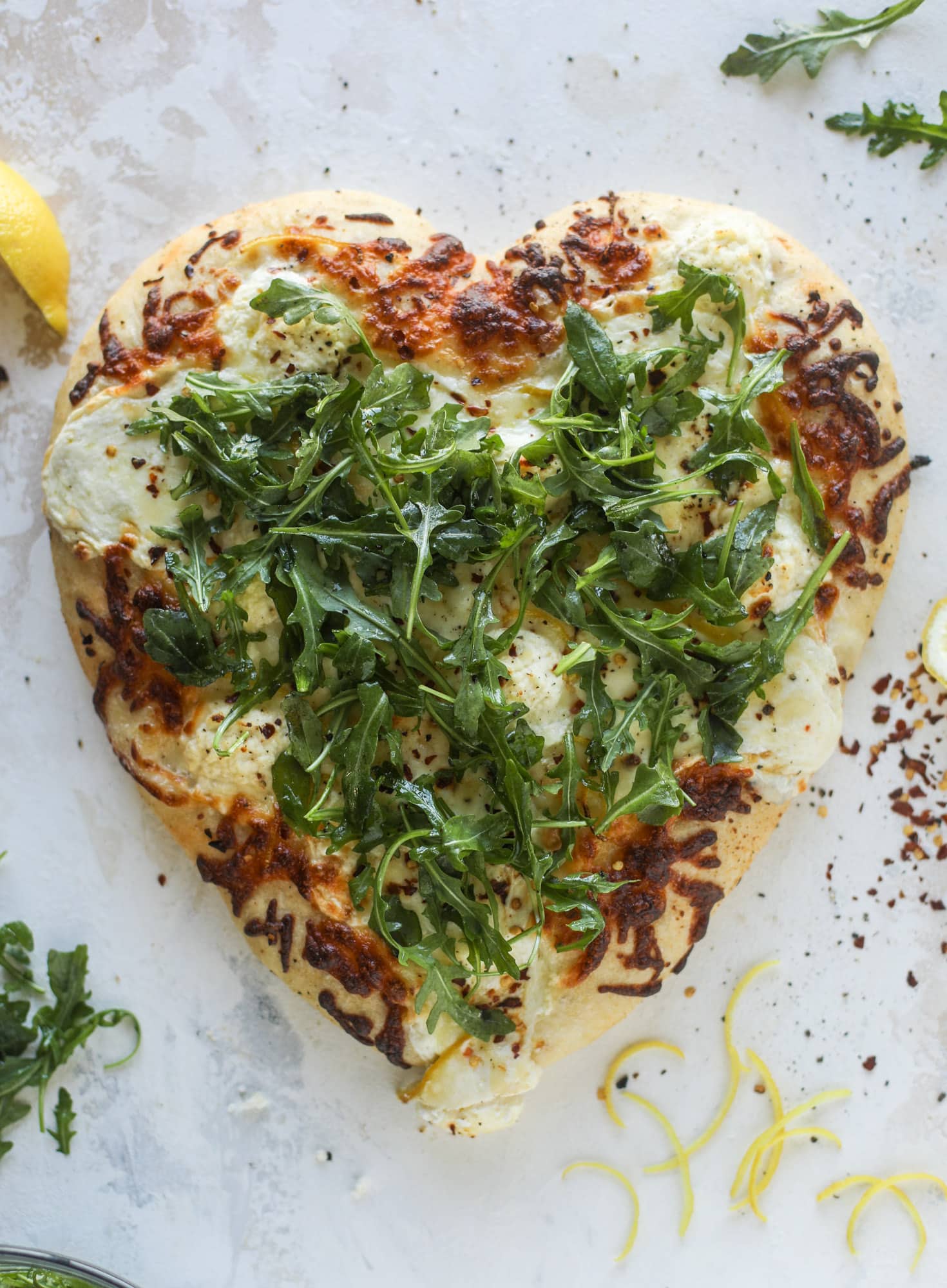 Our favorite white pizza recipe has four different kinds of cheese and comes on a garlic bread crust! Topped with crushed pepper and lemon - tons of flavor! I howsweeteats.com #white #pizza