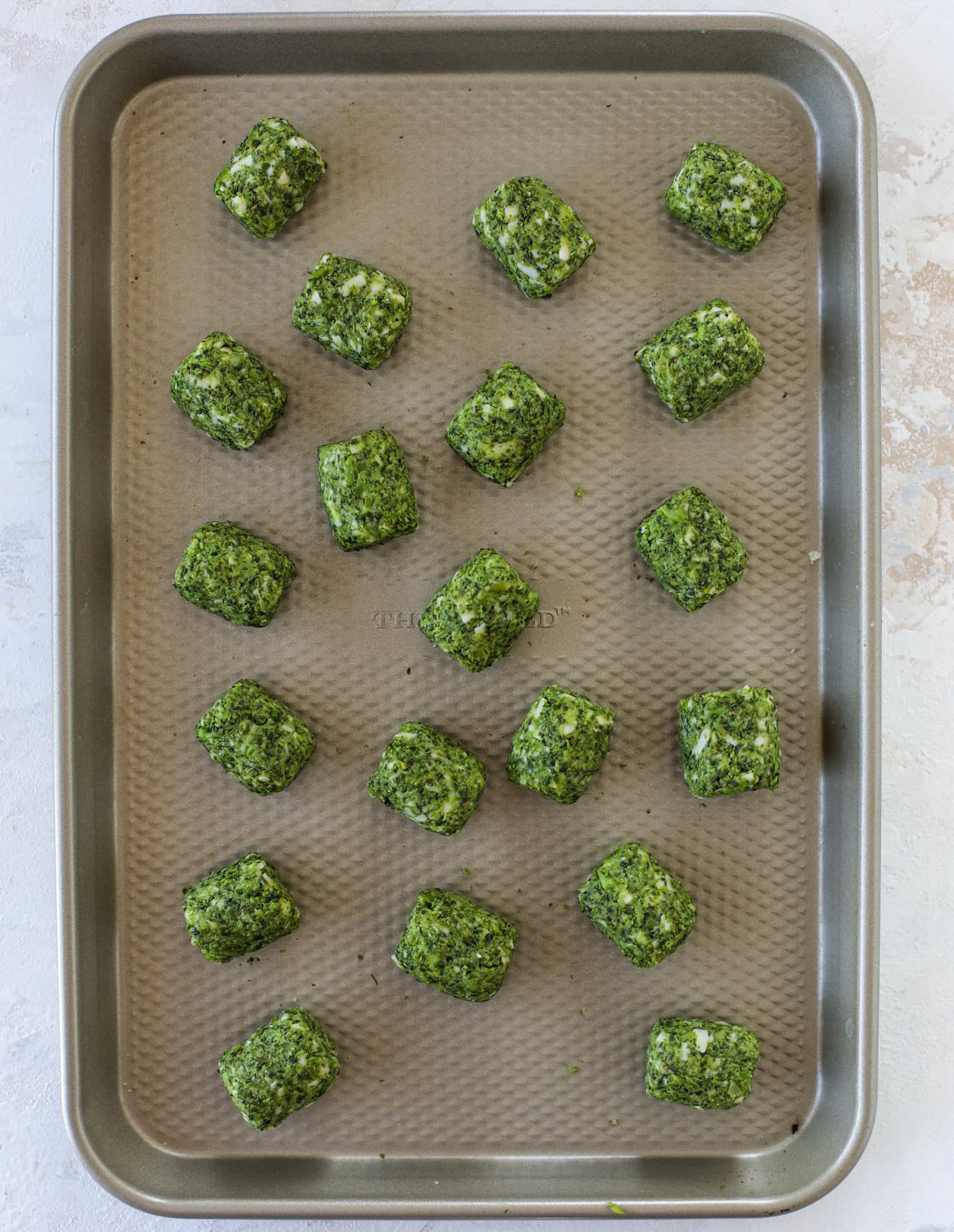 These broccoli cheddar tots are baked, crispy bites of broccoli and sharp cheddar cheese! So delicious and easy to throw together too. I howsweeteats.com #broccolicheddar #tots