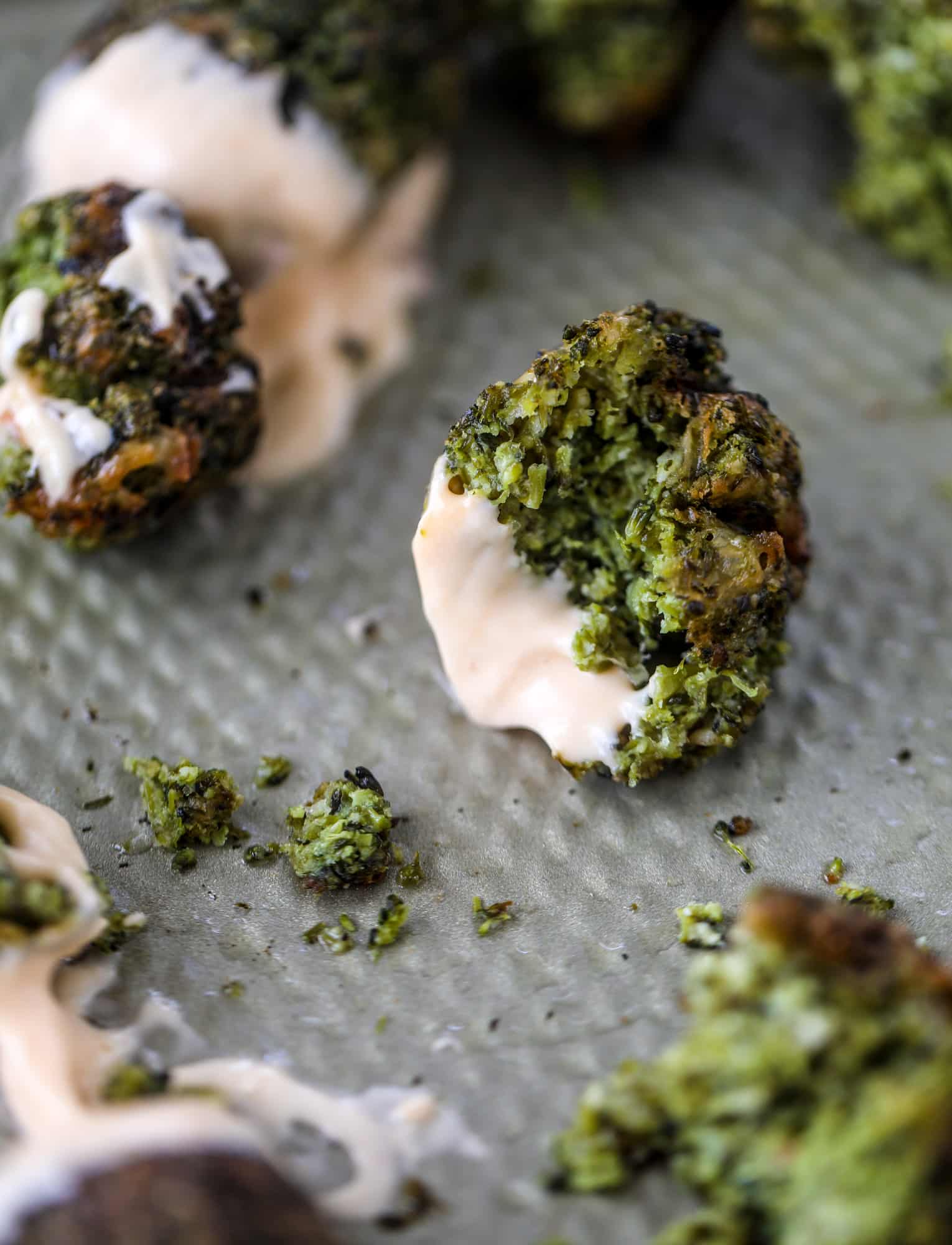 These broccoli cheddar tots are baked, crispy bites of broccoli and sharp cheddar cheese! So delicious and easy to throw together too. I howsweeteats.com #broccolicheddar #tots