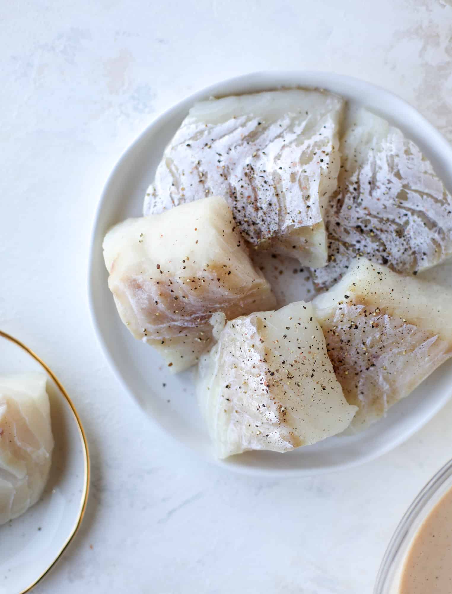 A light and crispy fish sandwich made with a simple beer batter and topped with a hearty, creamy kale cole slaw. Loaded with flavor! I howsweeteats.com #crispyfish #sandwich