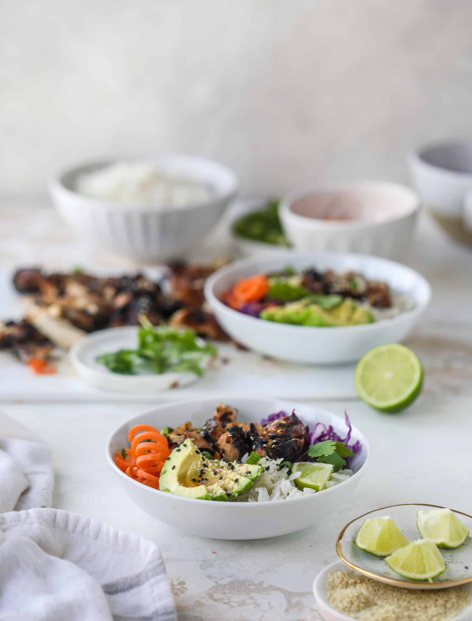 Korean chicken bowls are loaded with flavor: toasted sesame, soy sauce and lime come together over coconut rice and avocado to create a delicious meal! I howsweeteats.com #korean #chicken