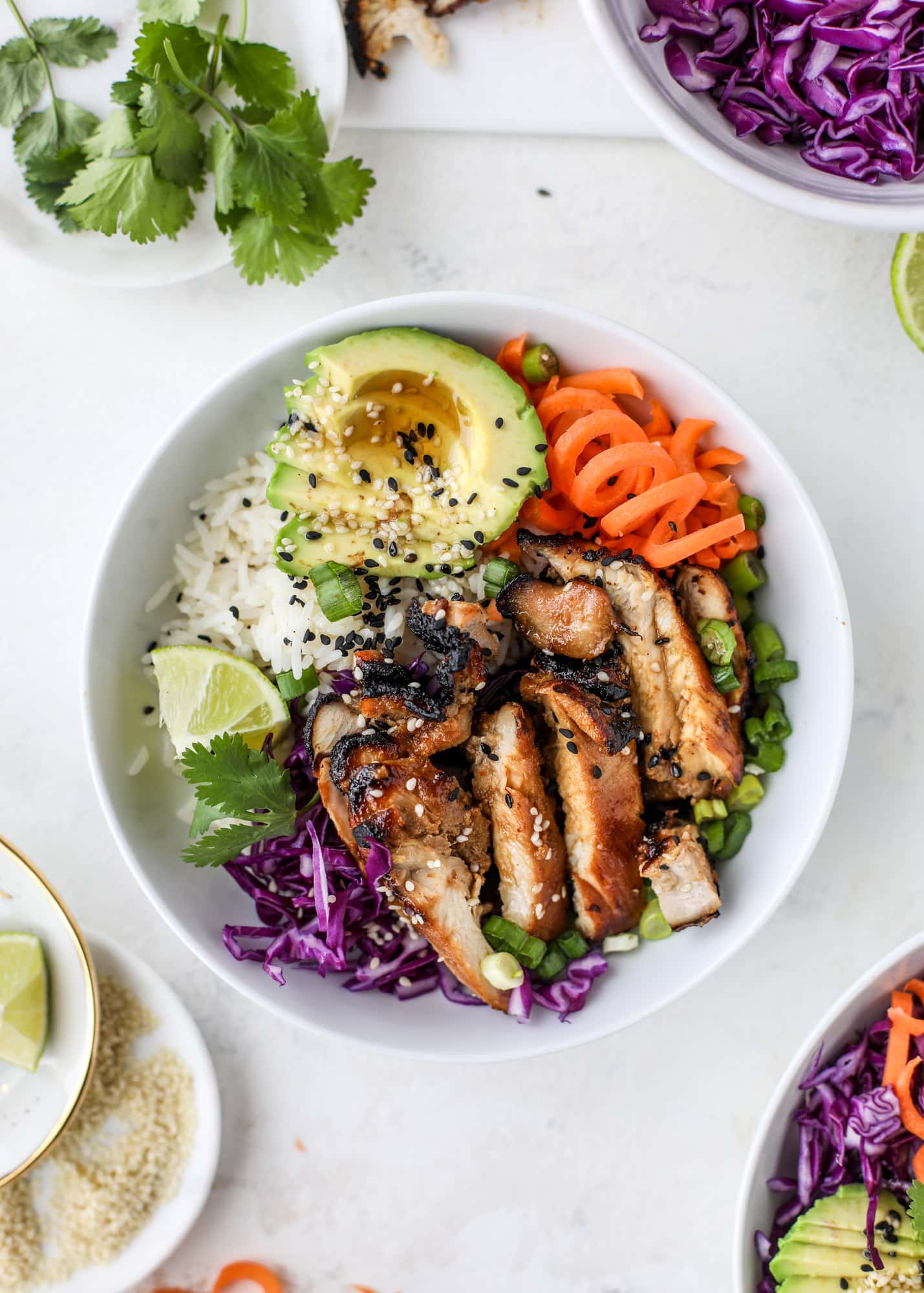 Korean chicken bowls are loaded with flavor: toasted sesame, soy sauce and lime come together over coconut rice and avocado to create a delicious meal! I howsweeteats.com #korean #chicken