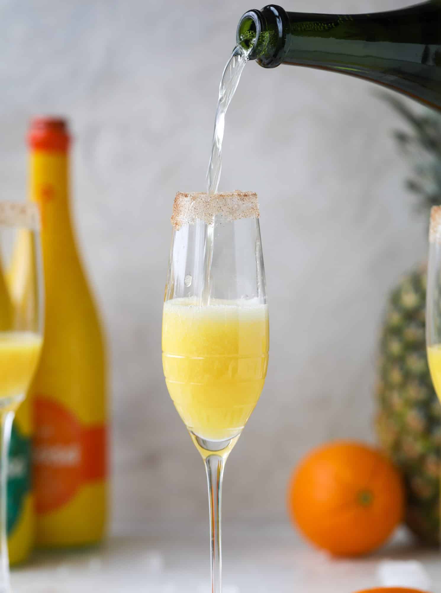 champagne pour into a mimosa