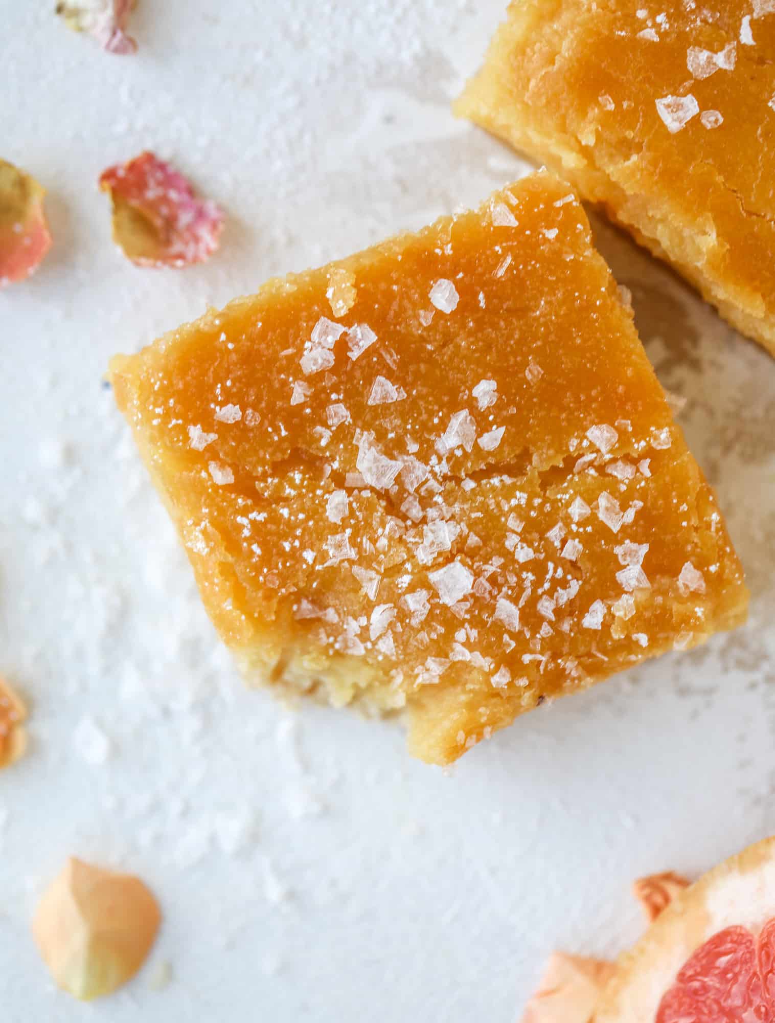 These salted citrus bars are made of both grapefruit and lemon curd on a buttery shortbread crust. Top with flaked sea salt for the perfect bite!