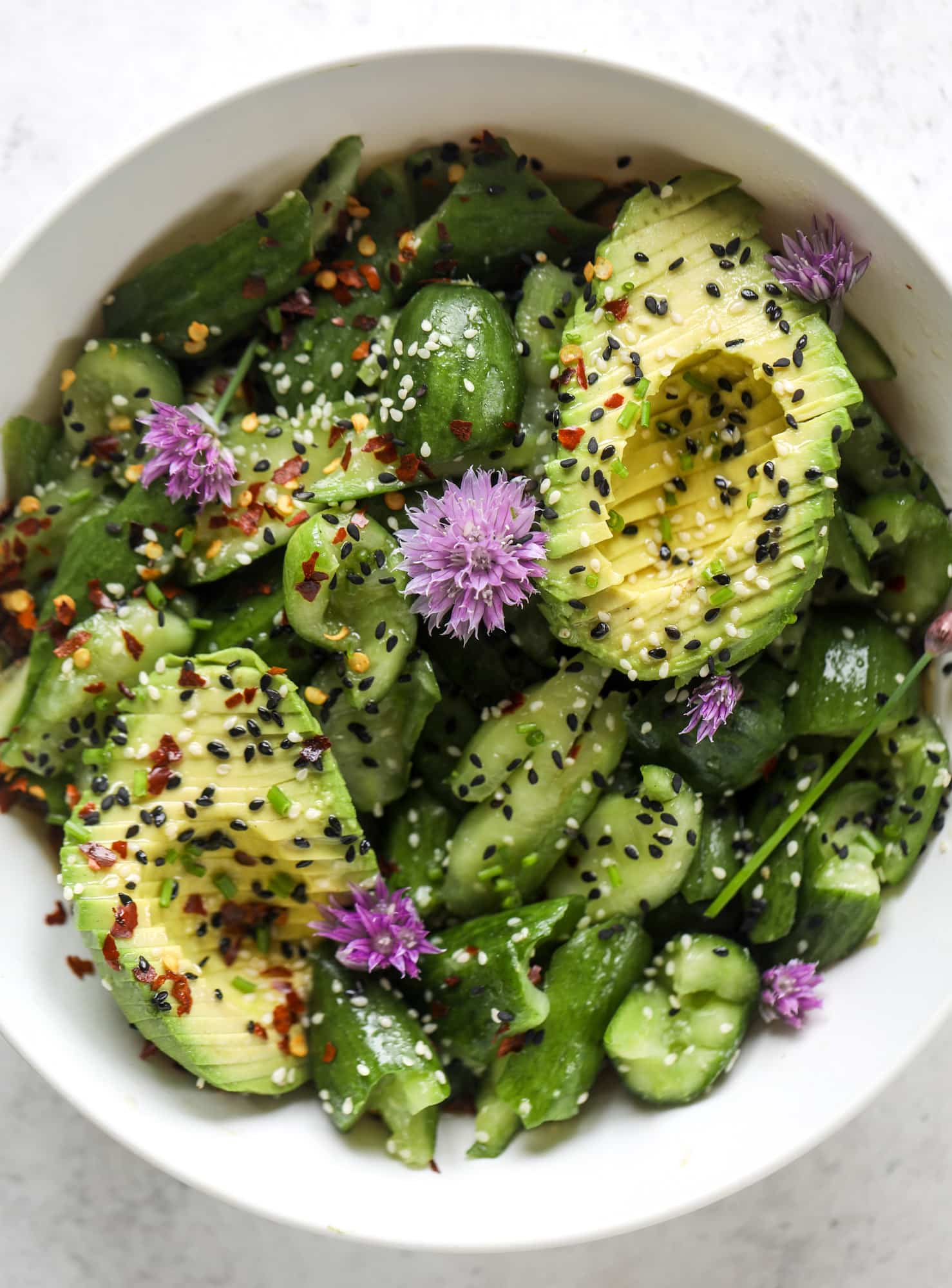 This smashed cucumber salad is so refreshing and perfect for summer! Served with avocado, toasted sesame oil and chives, it's ridiculously flavorful.