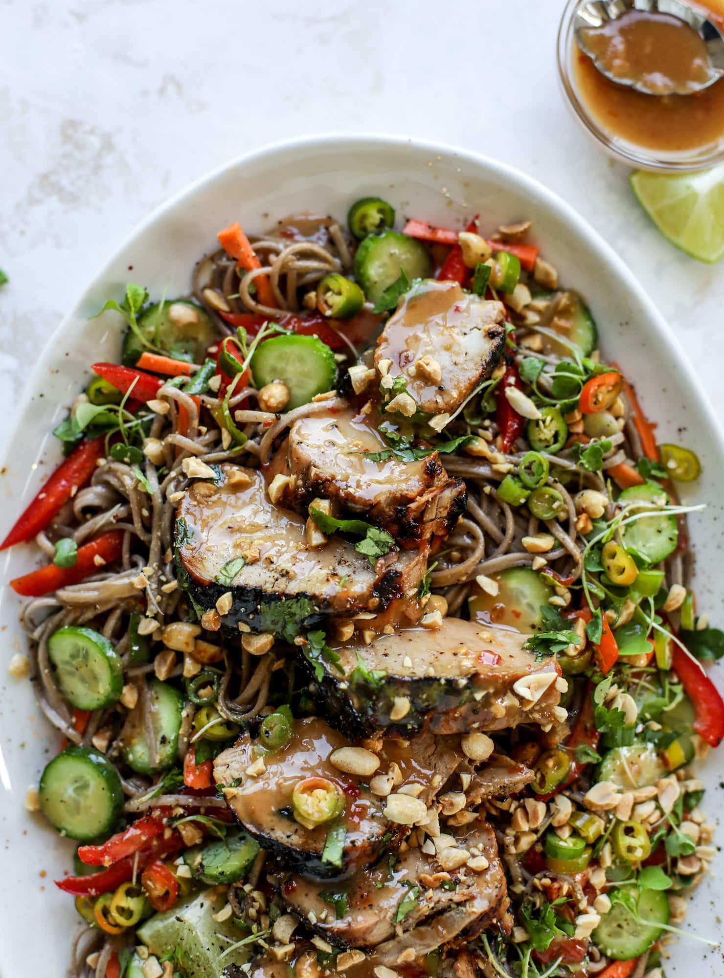 This grilled thai pork tenderloin is so easy, super flavorful, and the perfect weeknight meal when you serve it with a soda noodle salad. grilled thai pork tenderloin with soba noodle salad