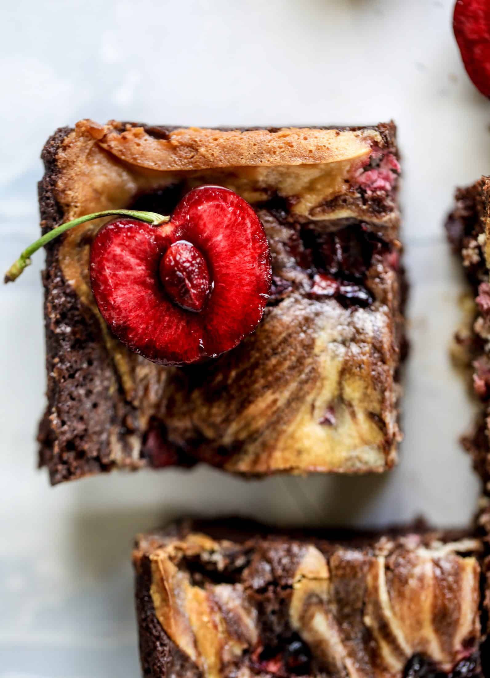 These cherry cheesecake swirl brownies are super rich and fudgy, filled with dark chocolate and fresh cherry, topped with a cherry cheesecake swirl.