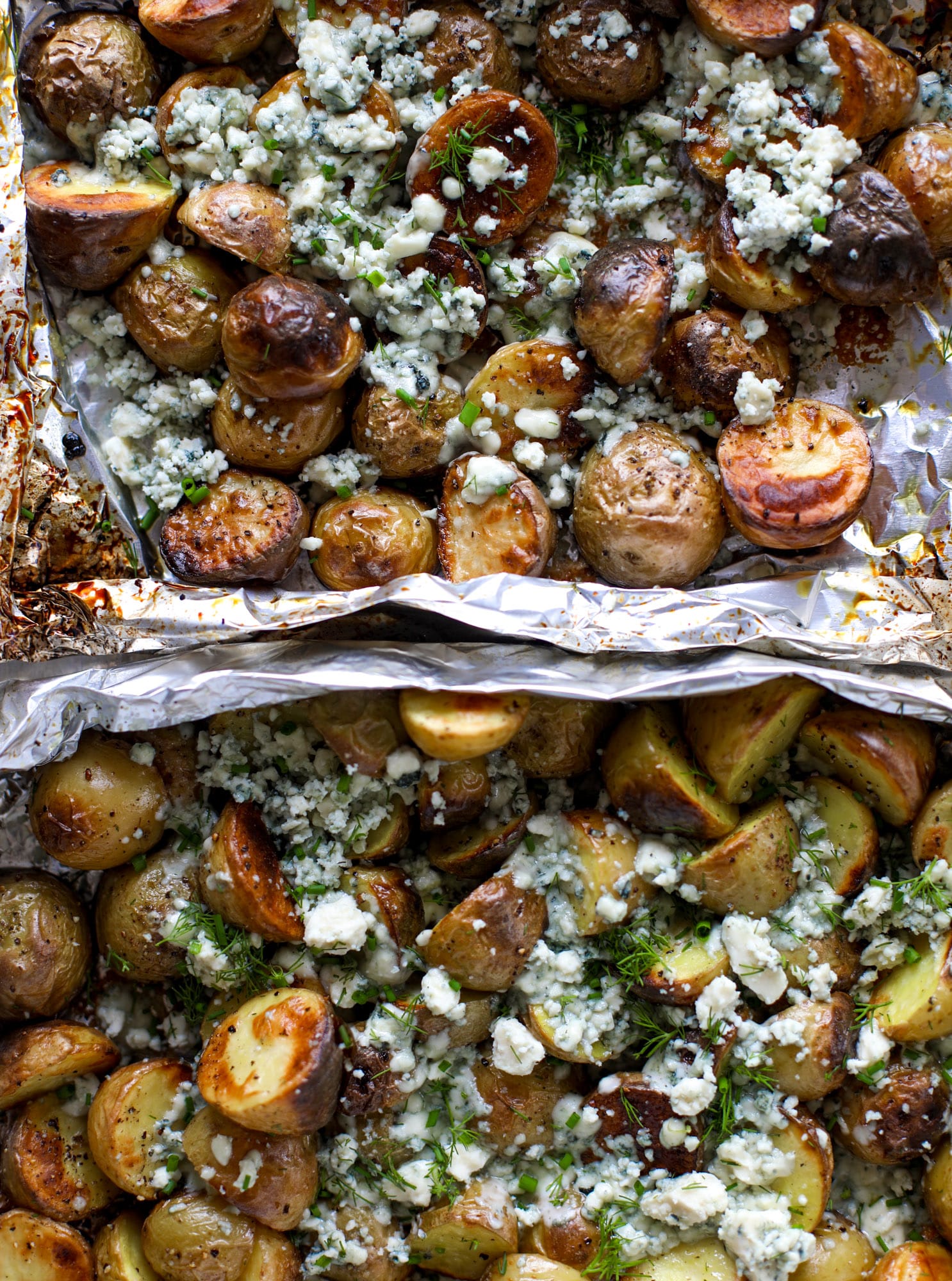 These grilled gorgonzola potatoes are loaded with flavor! Crispy, crunchy grilled bab golds topped with creamy blue cheese and fresh herbs.