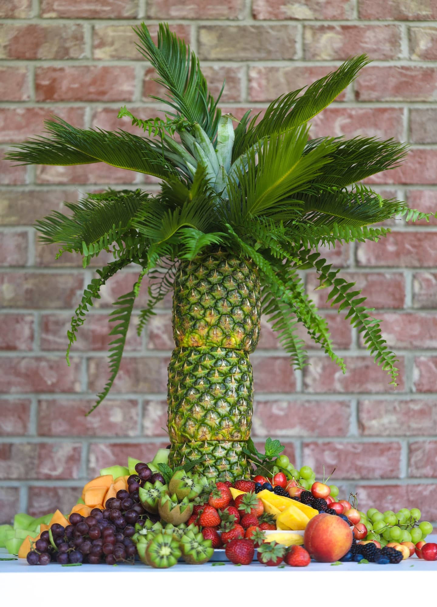 This is the cutest way to display fruit! A pineapple palm tree fruit tray will be the star of the show at your next summer BBQ or party!