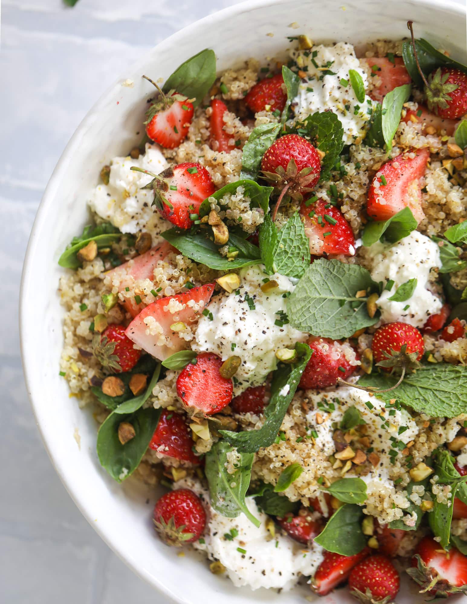 This strawberry quinoa salad is loaded with fresh herbs, burrata cheese and chopped pistachios. Topped with a lemon dressing, it's heavenly!