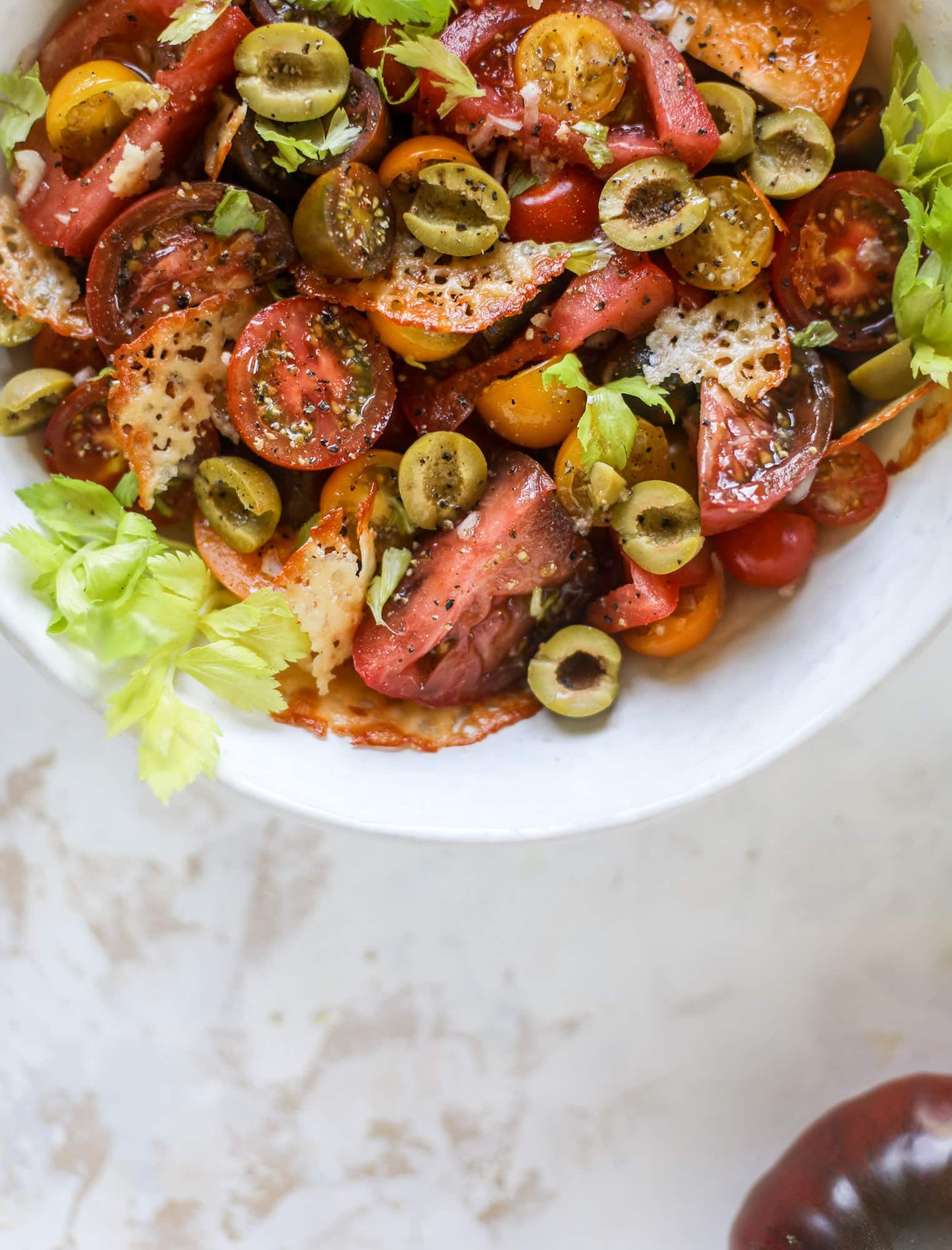This bloody mary tomato salad has all the incredible flavor of the bloody mary cocktail! Topped with cheddar crisps, it's delicious!