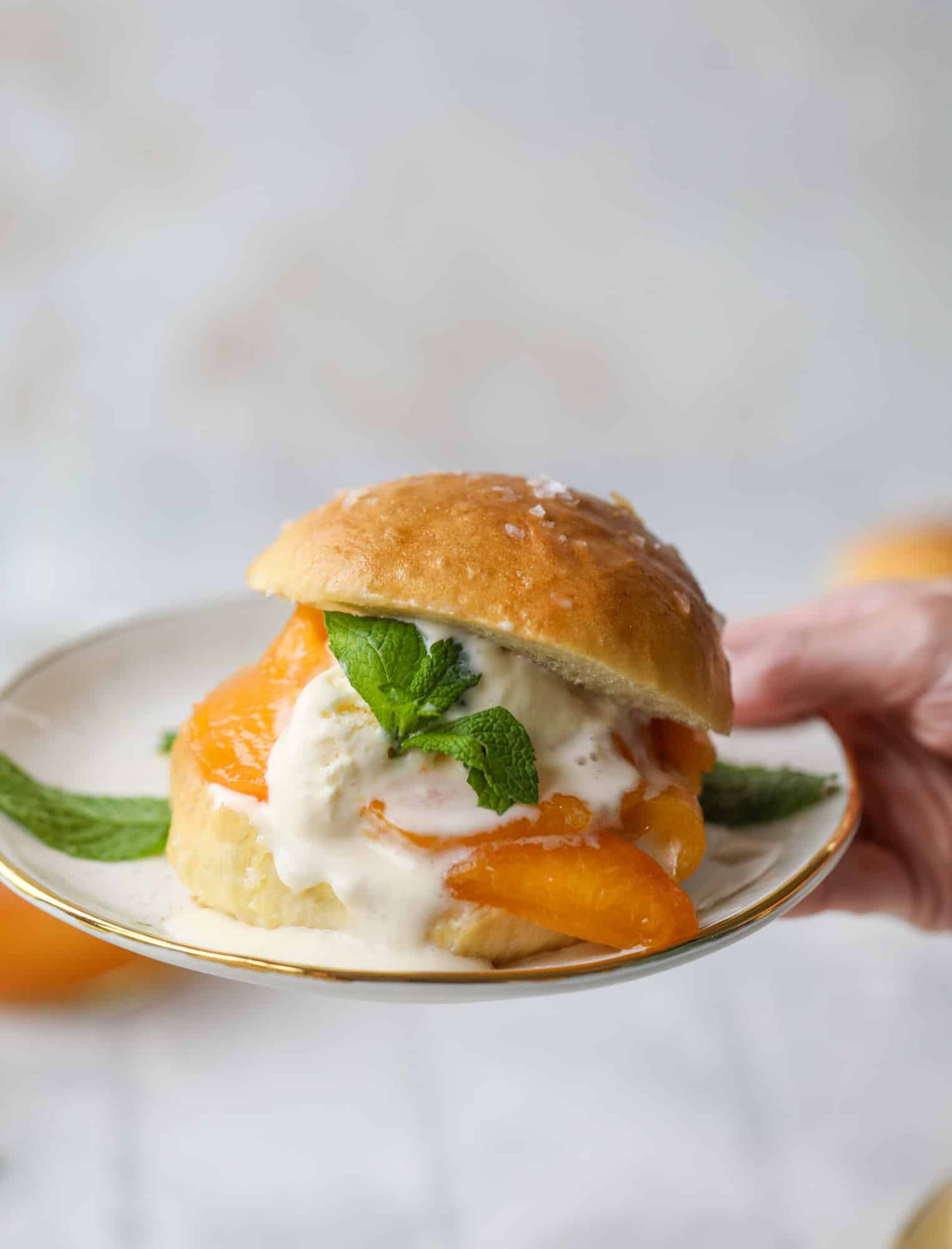 Prosecco peach shortcakes are out of these world! Prosecco poached peaches with vanilla ice cream on homemade salted brioche buns. To die for.