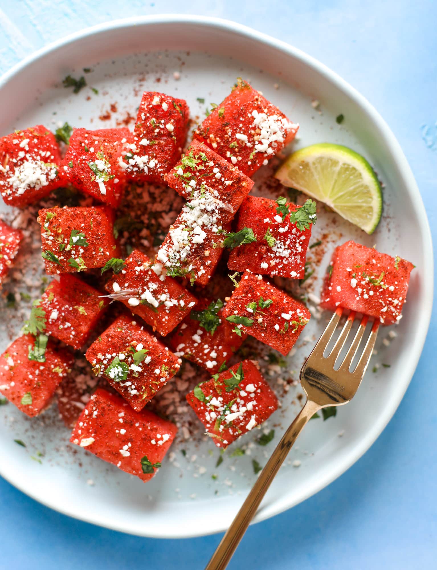 This chili lime watermelon is the perfect summer snack! It's savory and sweet with crumbled cotija cheese and lots of lime. Delish!
