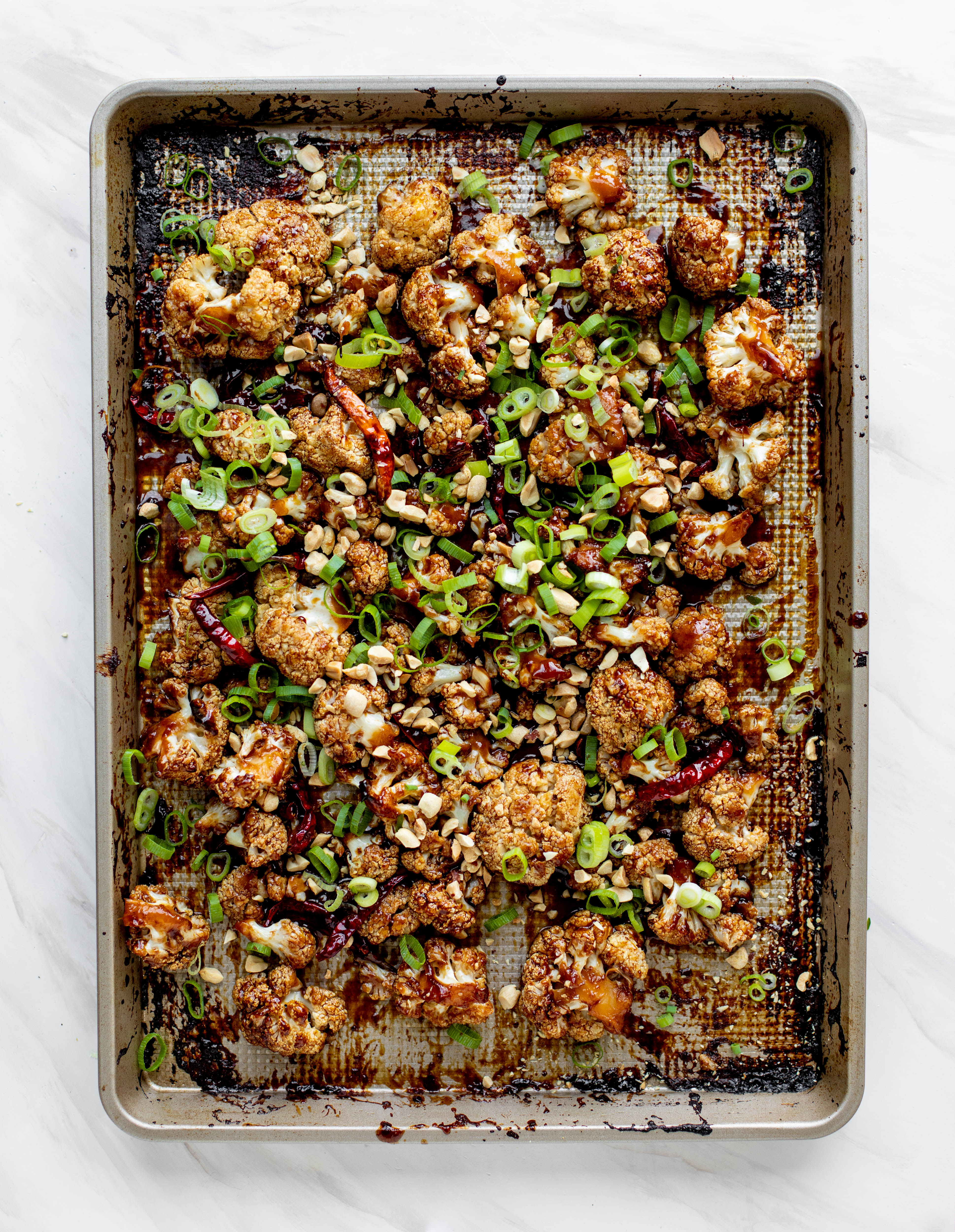 This kung pao cauliflower recipe is roasted on one sheet pan and covered in a delicious sauce! Serve alongside jasmine rice for the best dinner ever.