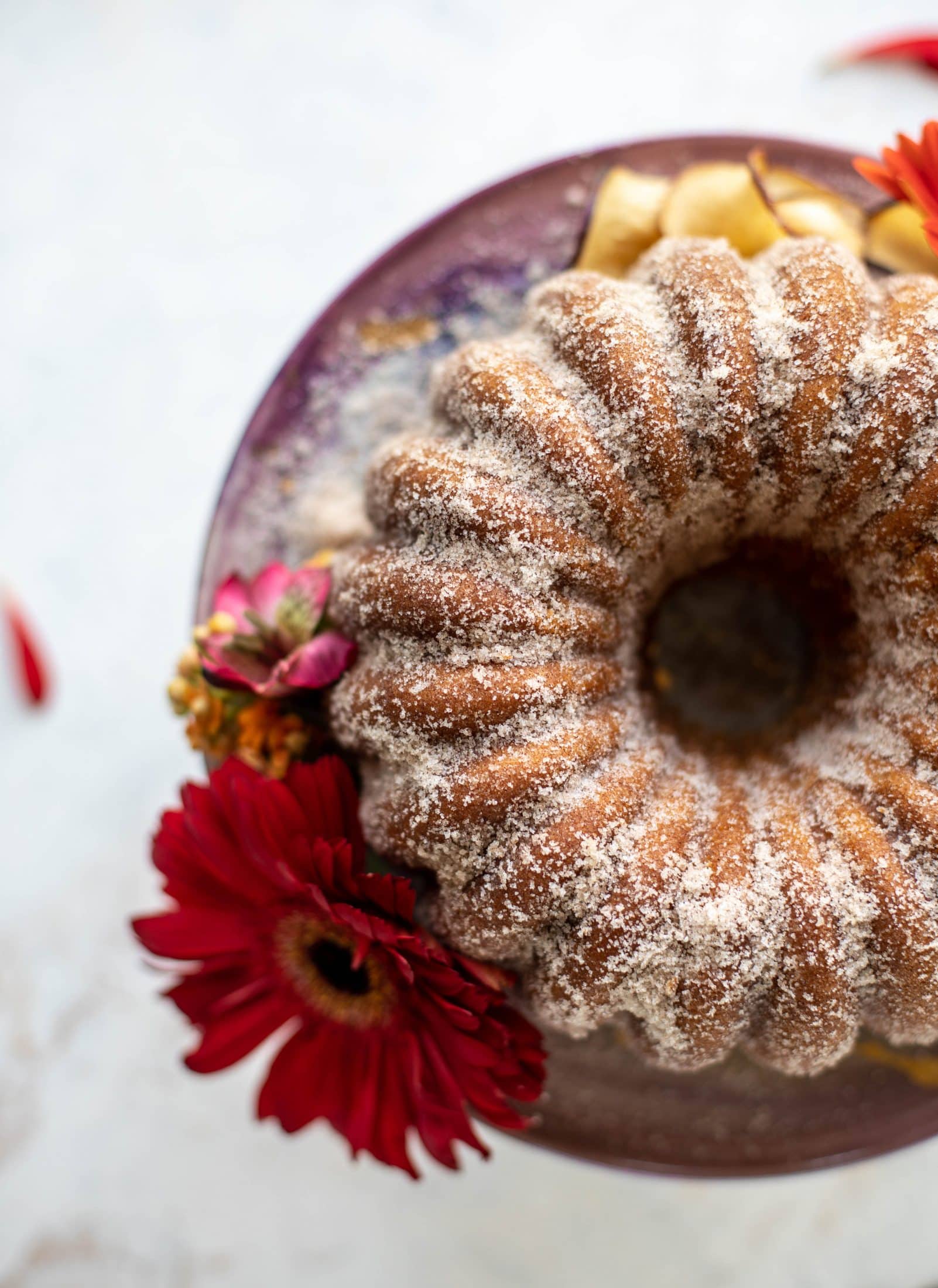 This apple cider donut cake is a huge fall crowd pleaser! Covered in cinnamon sugar and fluffy to perfection. It's incredible!