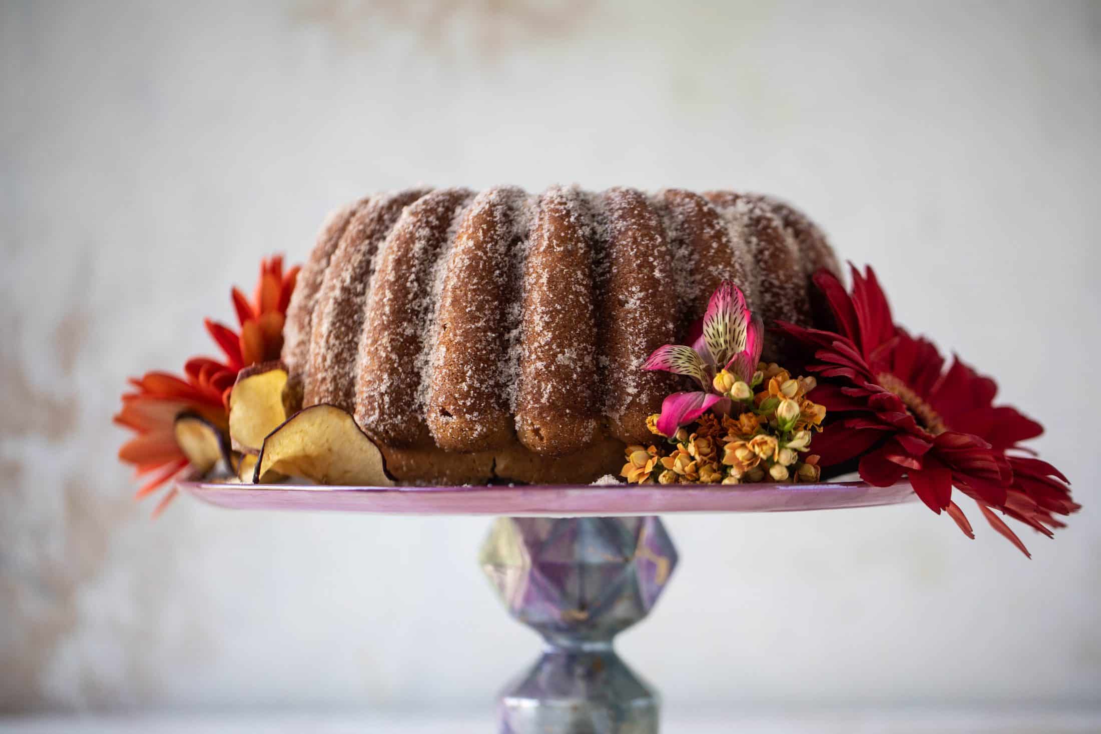 This apple cider donut cake is a huge fall crowd pleaser! Covered in cinnamon sugar and fluffy to perfection. It's incredible!