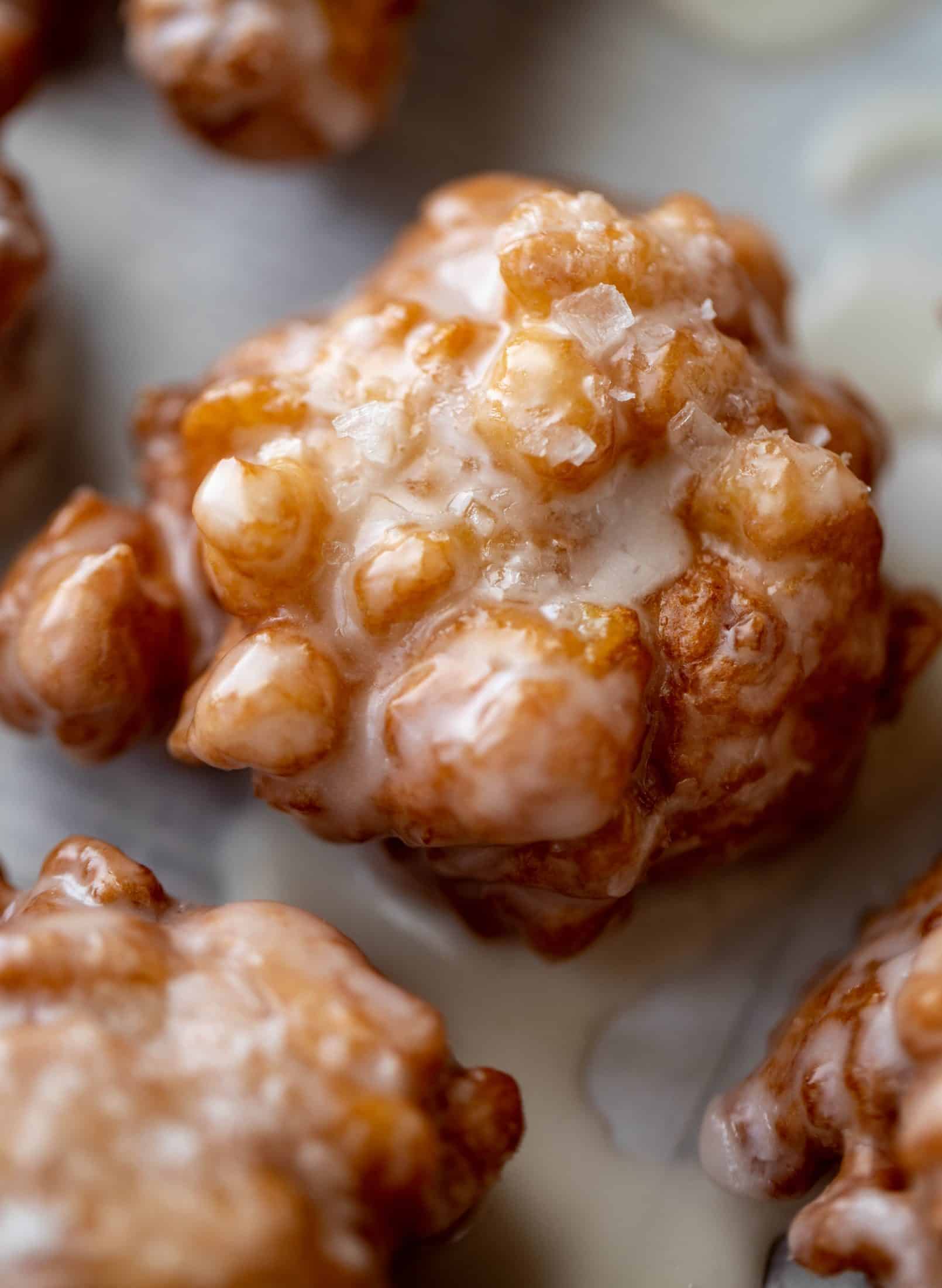 These salted apple fritters use honeycrisp apples and flaked sea salt for a fall flavor explosion. These are the best treat ever!