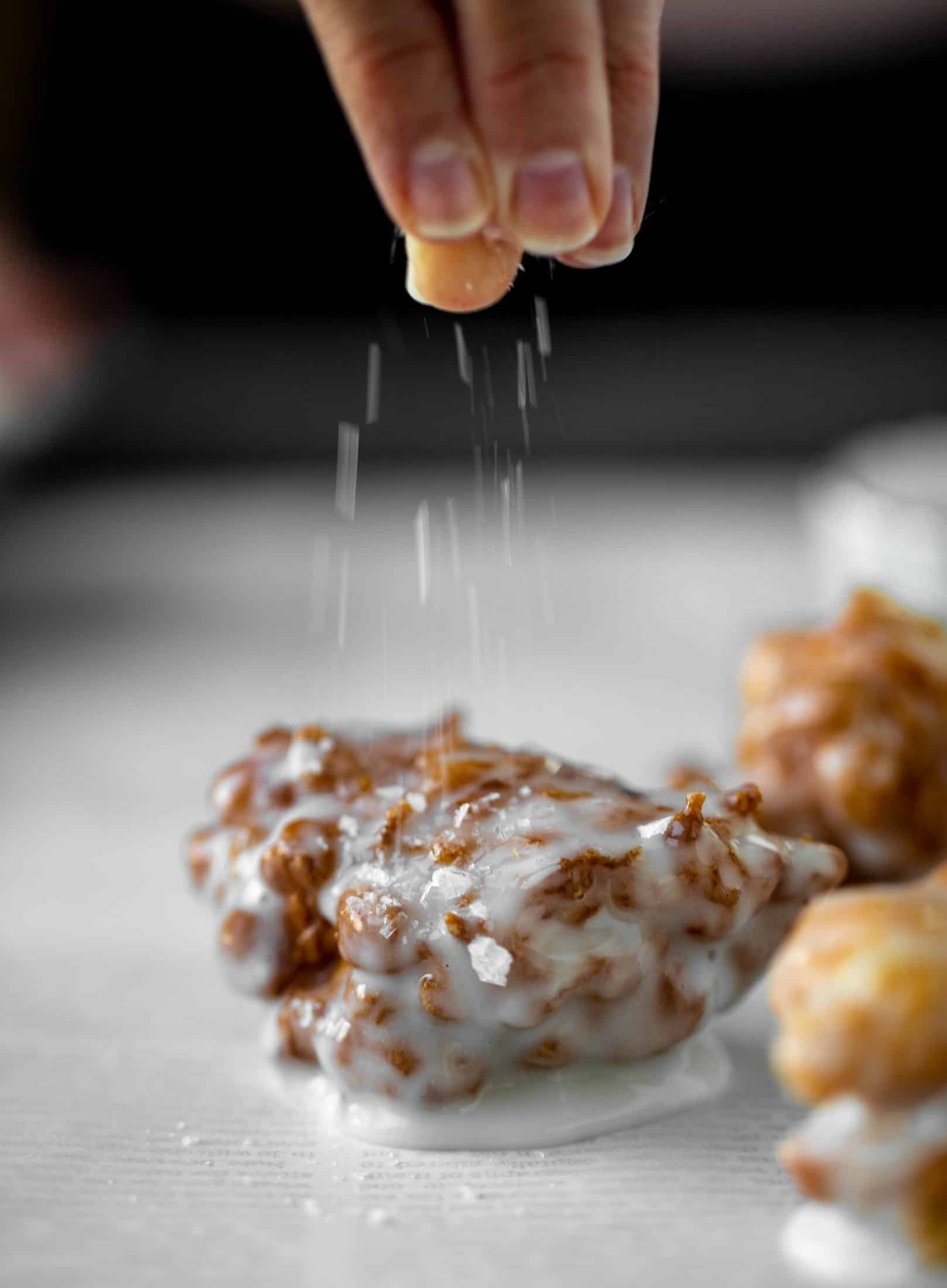 These salted apple fritters use honeycrisp apples and flaked sea salt for a fall flavor explosion. These are the best treat ever!
