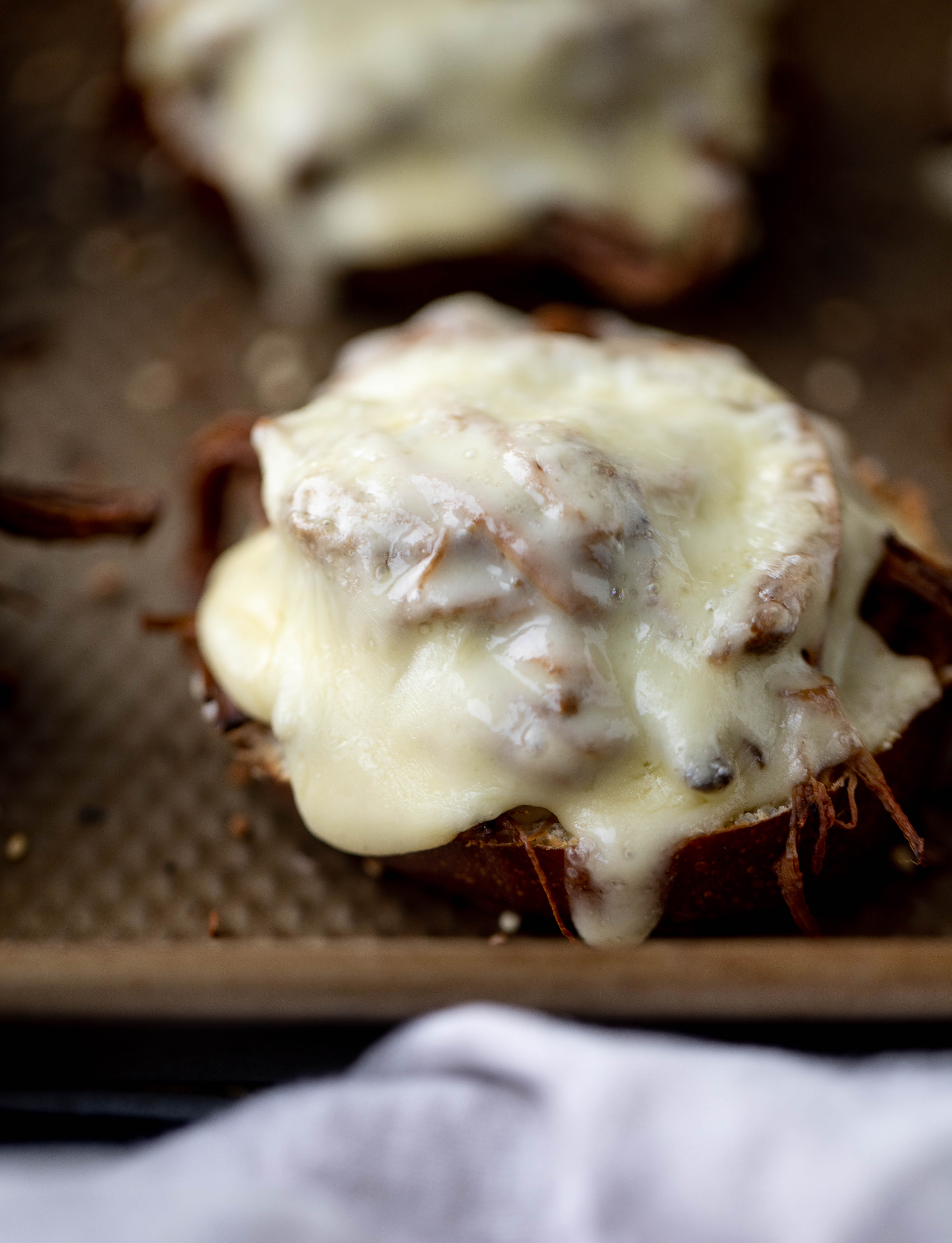 This pumpkin beer brisket melts are smothered in havarti cheese and served on everything pretzel rolls. They are ridiculously delicious!