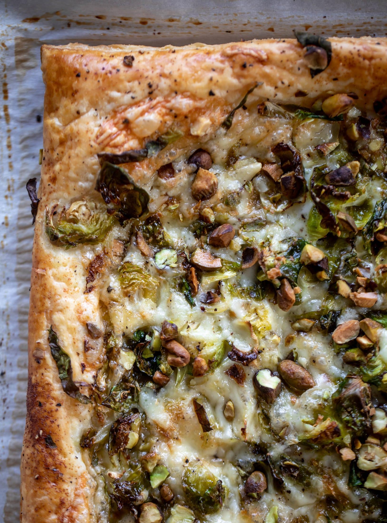 This brussels sprouts tart has a ton of flavor! Melty fontina, sliced brussels and crunchy pistachios all on top of puff pastry. Delish!
