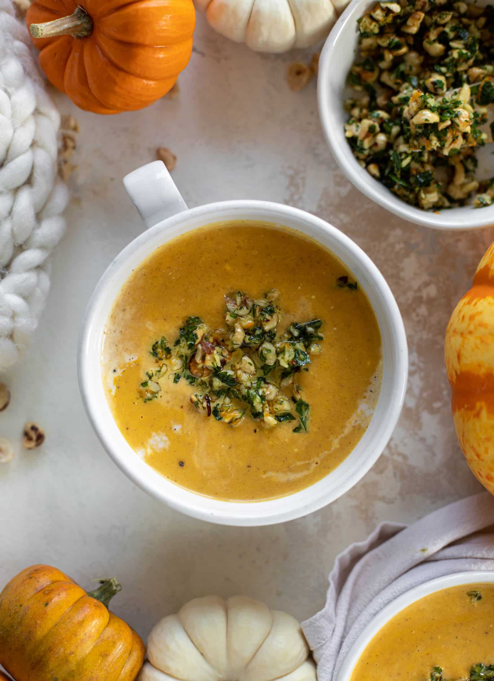 This pumpkin cream soup is silky smooth and delicious, then topped with a roasted hazelnut gremolata for extra flavor and crunch!