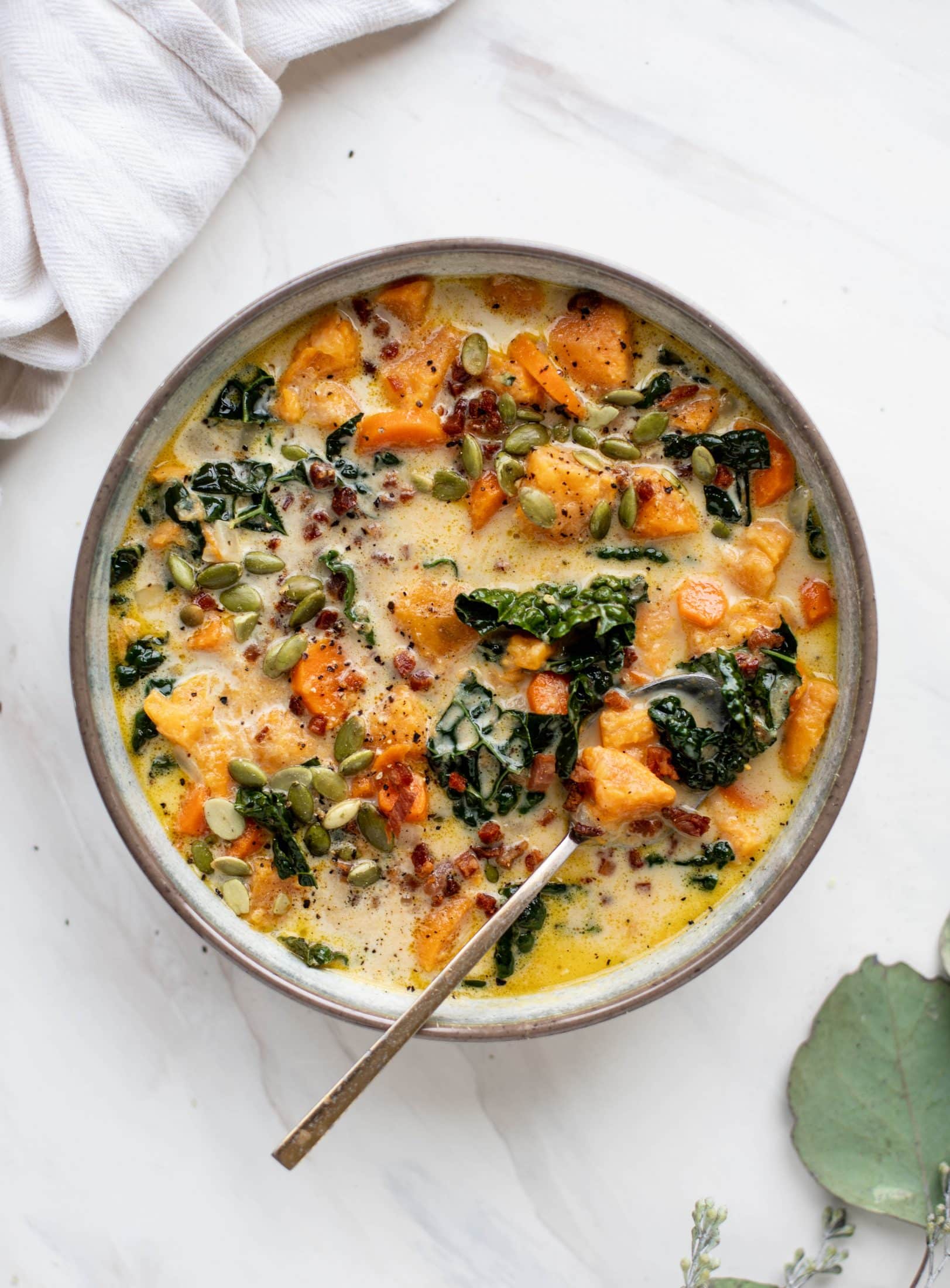 This sweet potato chowder is a hug in a bowl! Made with lots of greens and crunchy pancetta and pepitas for topping, it's a perfect weeknight meal.