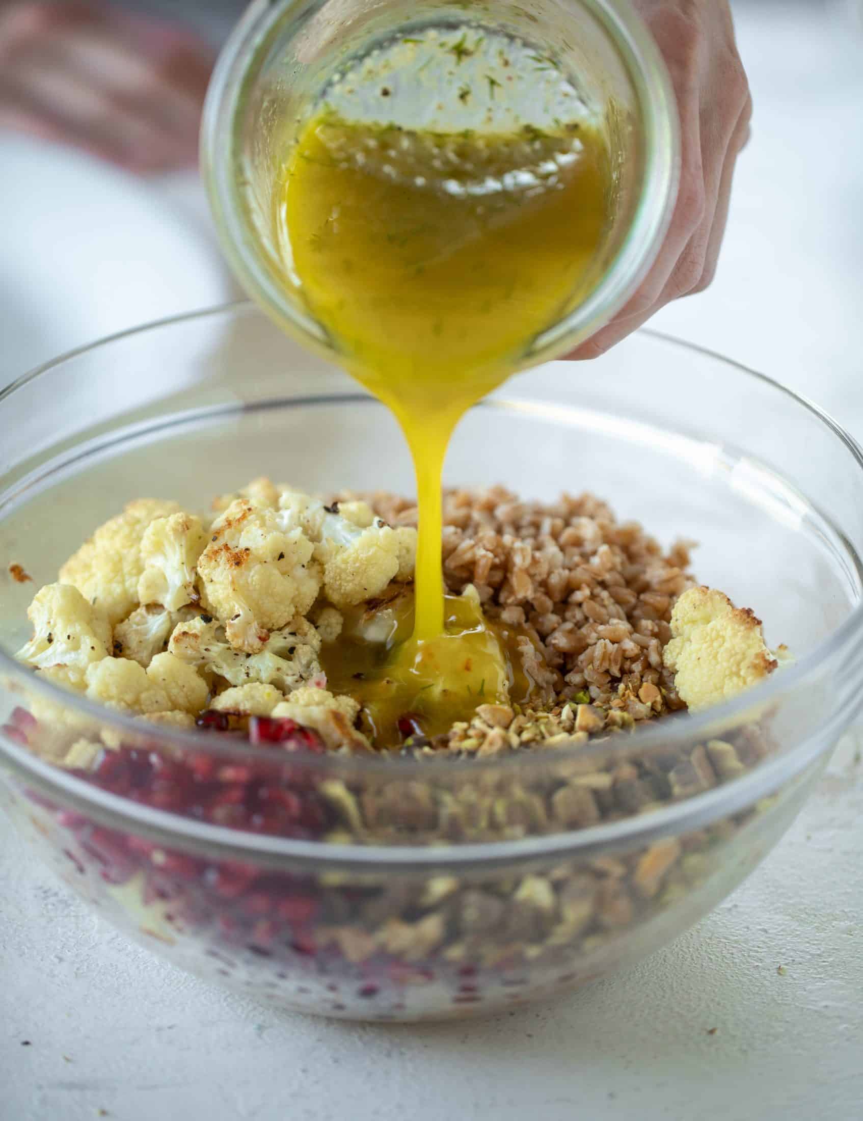 This cauliflower farro salad is filled with roasted cauliflower, pistachios, pomegranates and drizzled with a dill vinaigrette. Delicious!