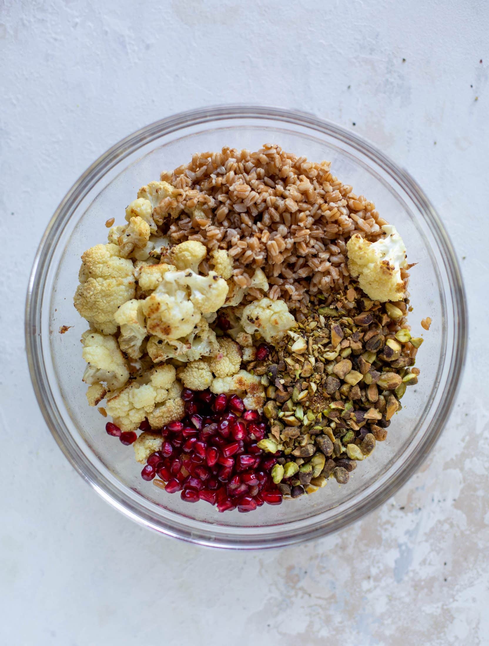 This cauliflower farro salad is filled with roasted cauliflower, pistachios, pomegranates and drizzled with a dill vinaigrette. Delicious!