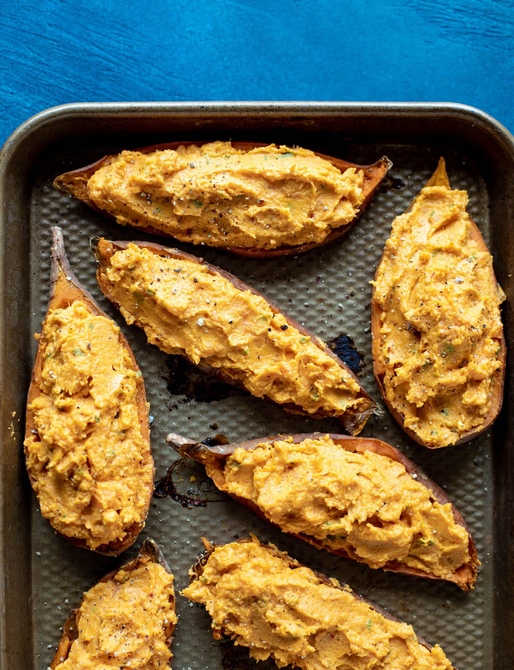 These twice baked sweet potatoes are whipped with crispy sage and pumpkin puree! Topped with cheese and baked until melty, they are super delish.