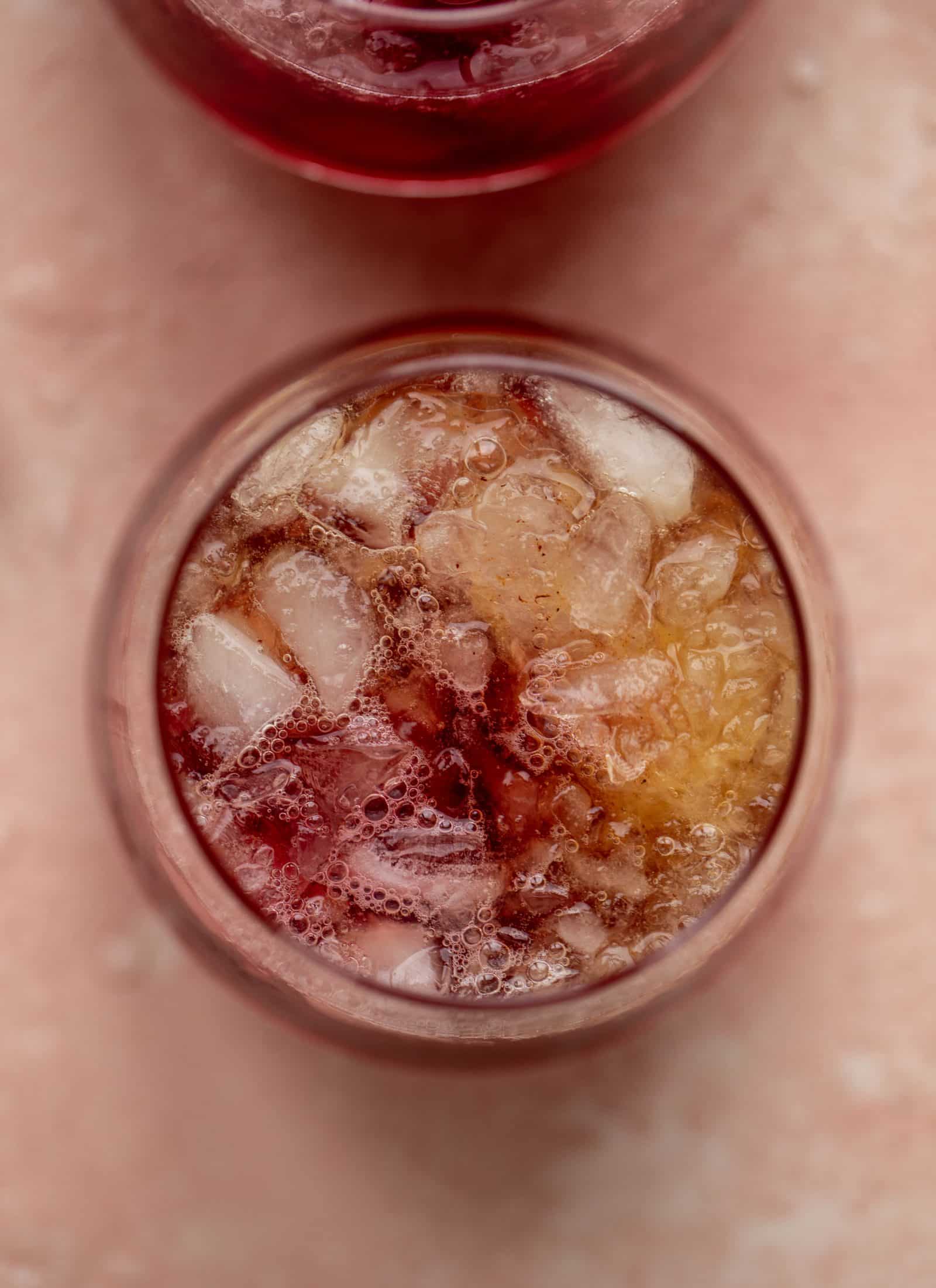 This cranberry cobbler smash is perfect for the holiday season! Bourbon, cinnamon simple syrup and cranberry juice - it's spiced and warming and wonderful.
