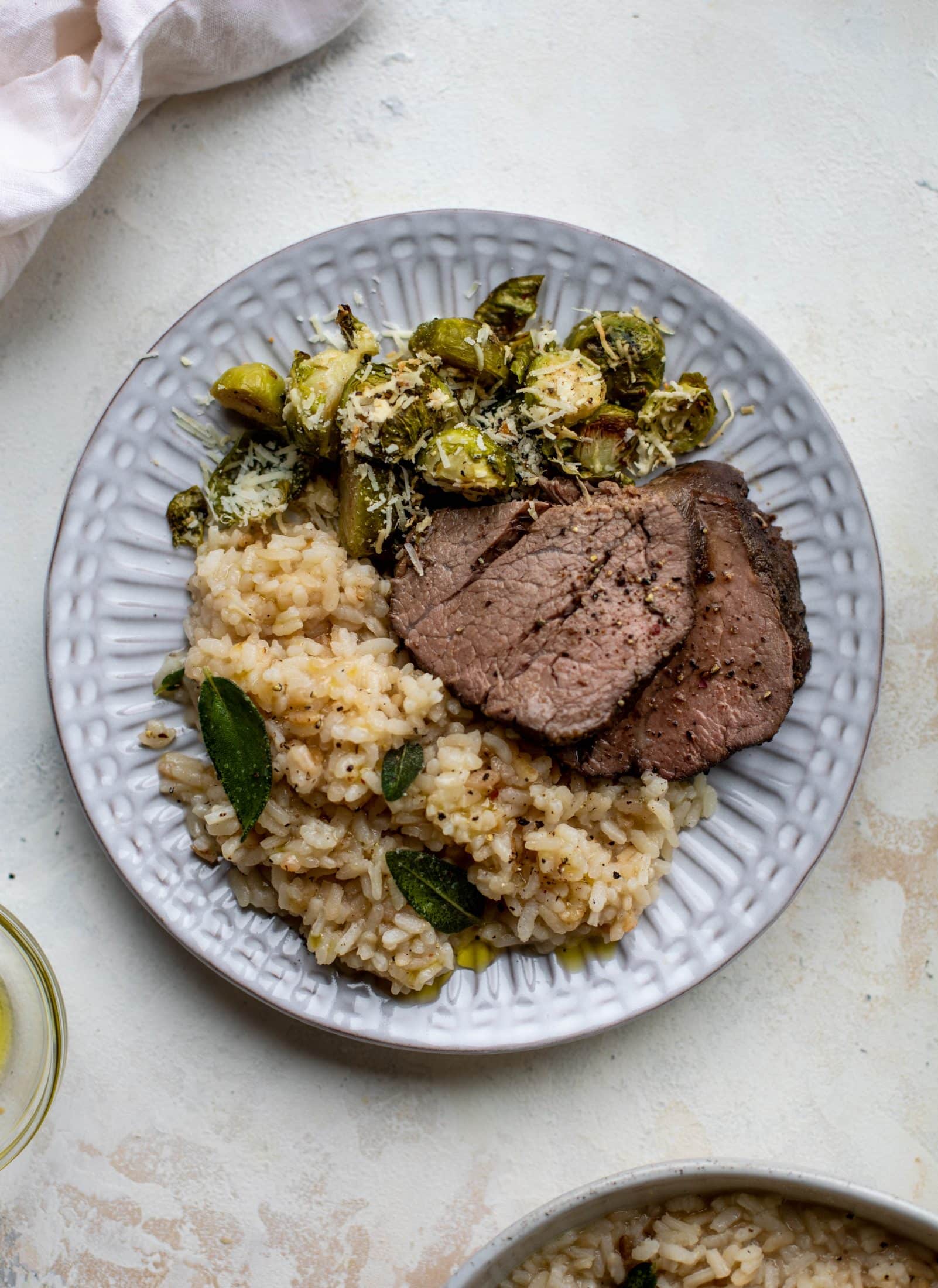 The ultimate special occasion meal! Espresso crusted filet paired with truffle sage risotto and cacio e pepe brussels. So much flavor - it's perfect for the holidays!