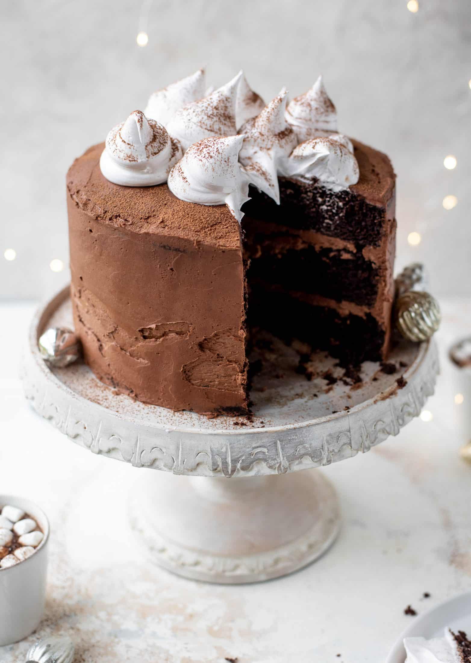 This hot cocoa cake is made with the fudgiest chocolate cake, smothered in chocolate cream cheese frosting and dolloped with whipped marshmallow!