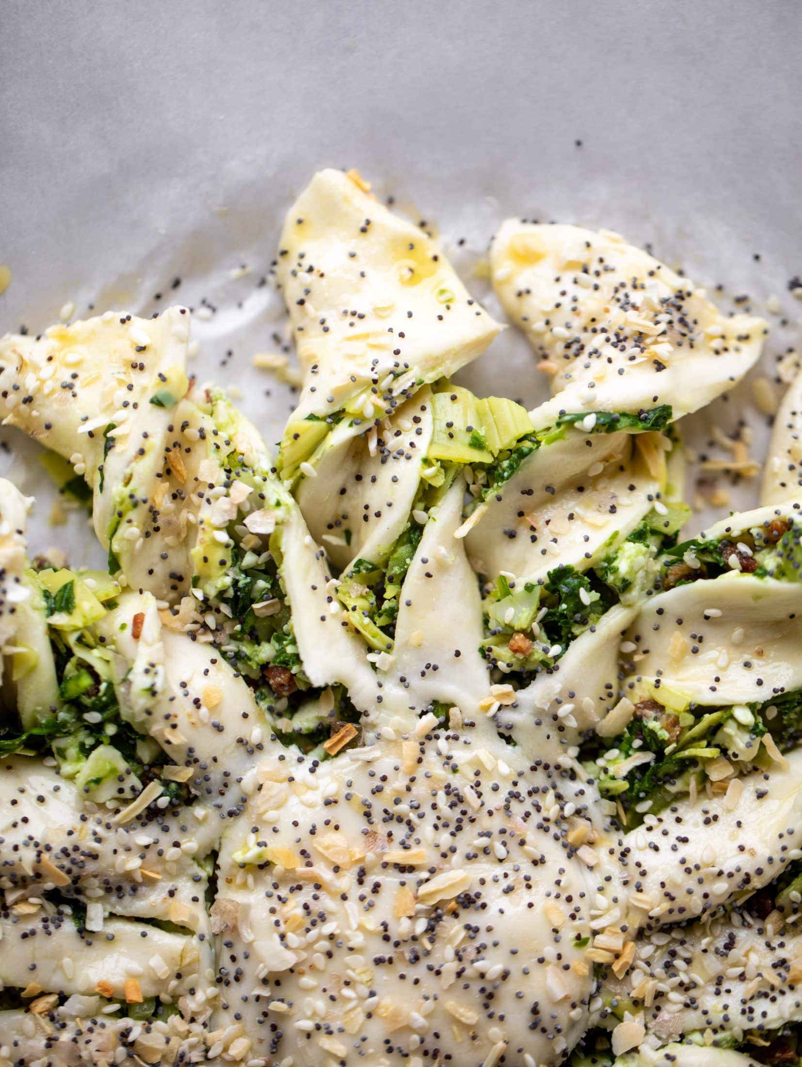 These spinach artichoke twists are filled with cheese and pancetta. They are buttery and flaky on the outside then sprinkled with everything seasoning. YUM.