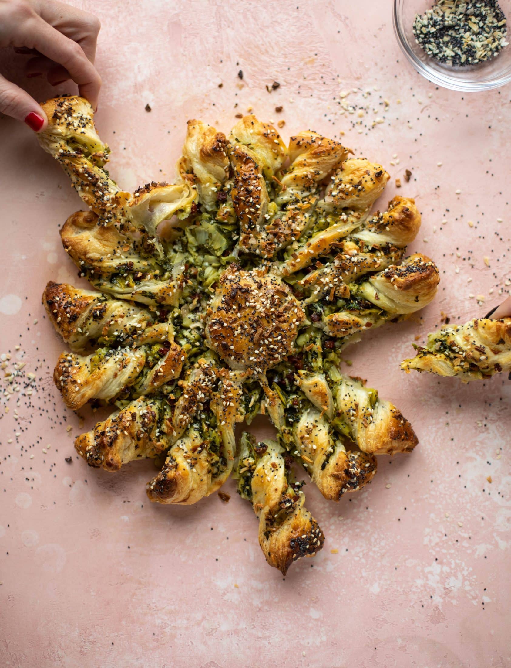 These spinach artichoke twists are filled with cheese and pancetta. They are buttery and flaky on the outside then sprinkled with everything seasoning. YUM.