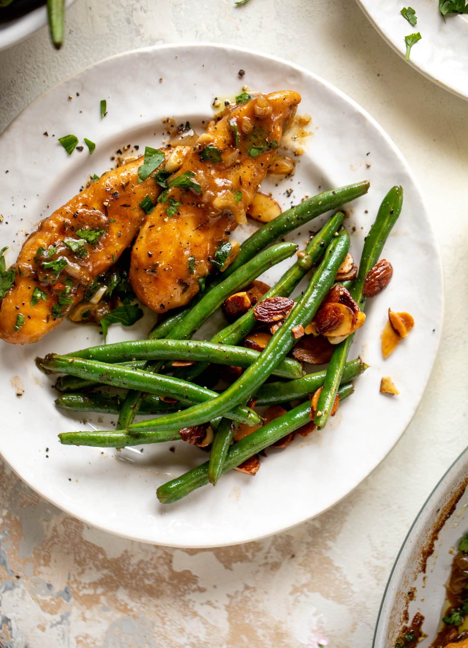 My mom's chicken marsala is easy and ridiculously flavorful! It's made without mushrooms and served alongside almond brown butter green beans.
