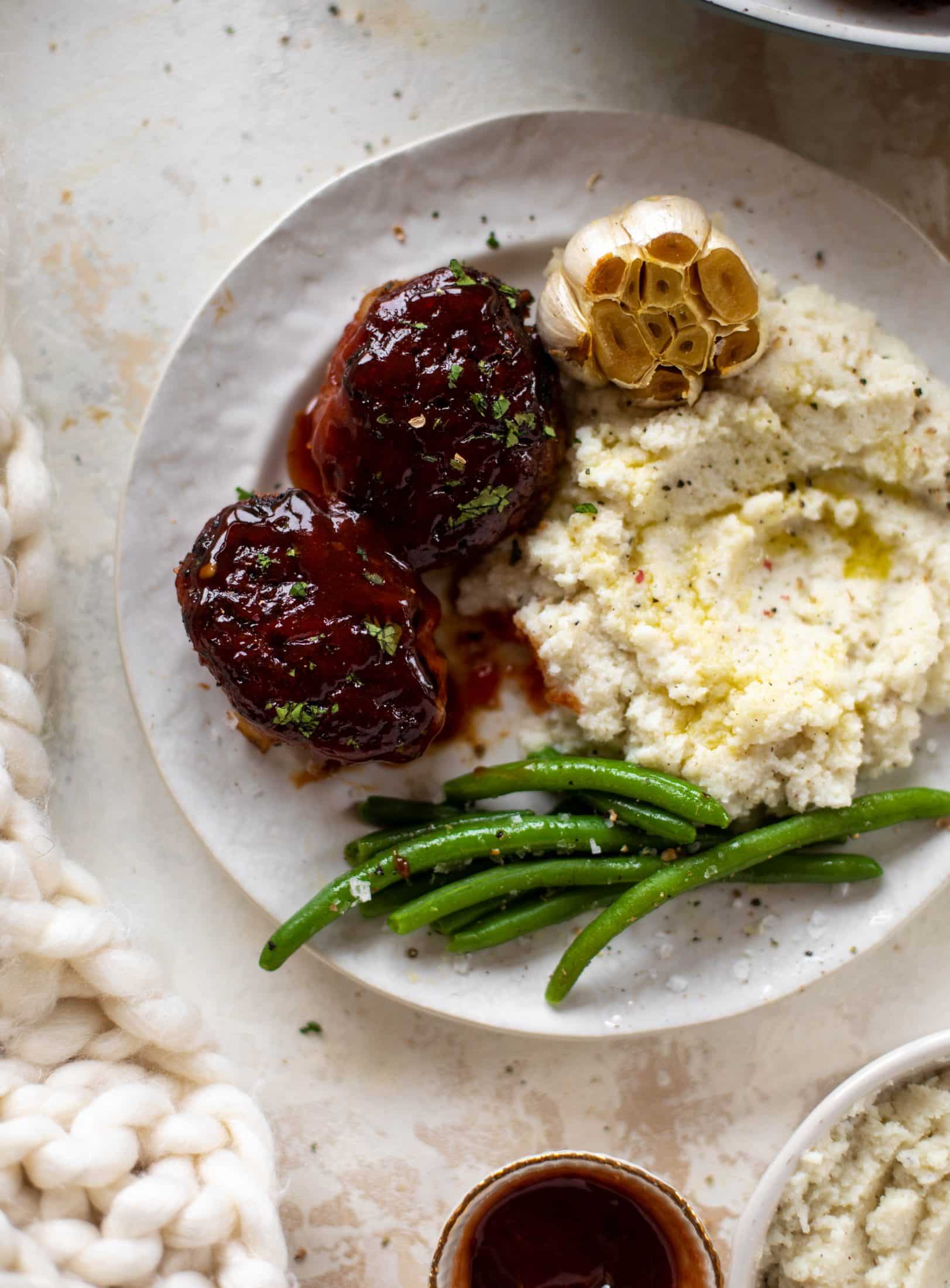 Mini turkey meatloaf in a skillet is the best weeknight dinner idea! Serve with roasted garlic cauliflower mash and your favorite green veggie on the side.