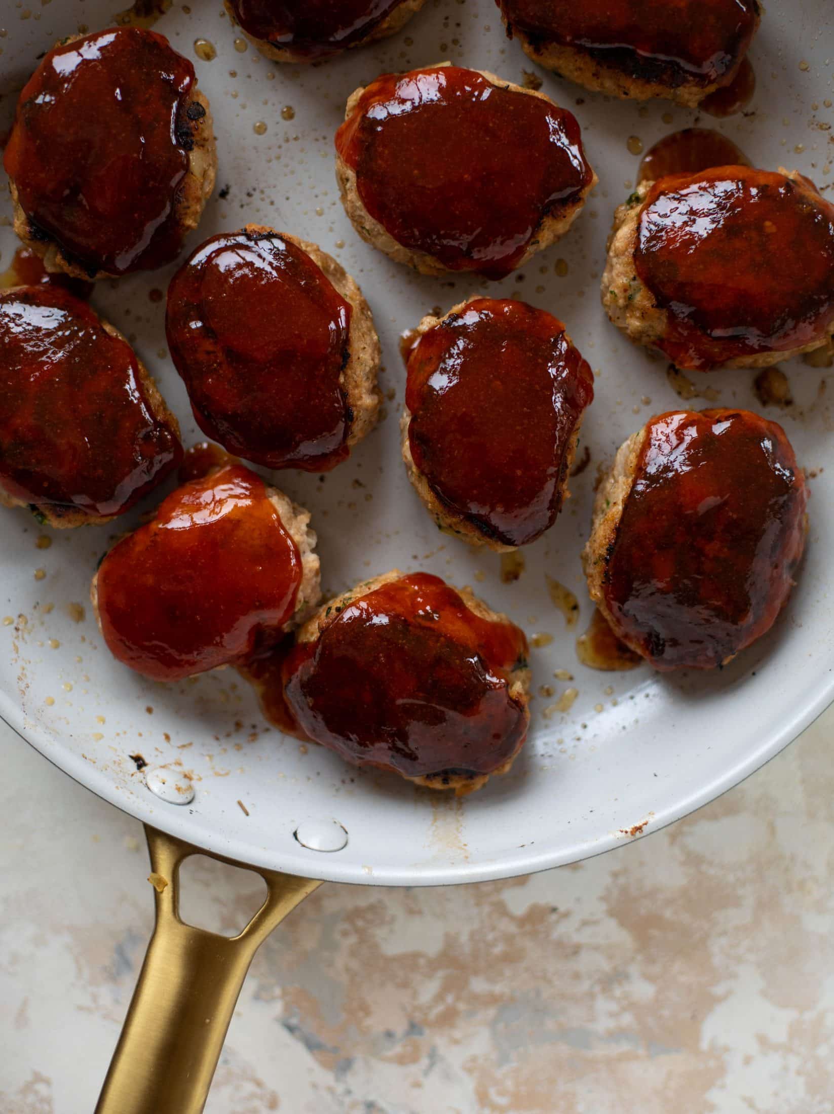 Mini turkey meatloaf in a skillet is the best weeknight dinner idea! Serve with roasted garlic cauliflower mash and your favorite green veggie on the side.