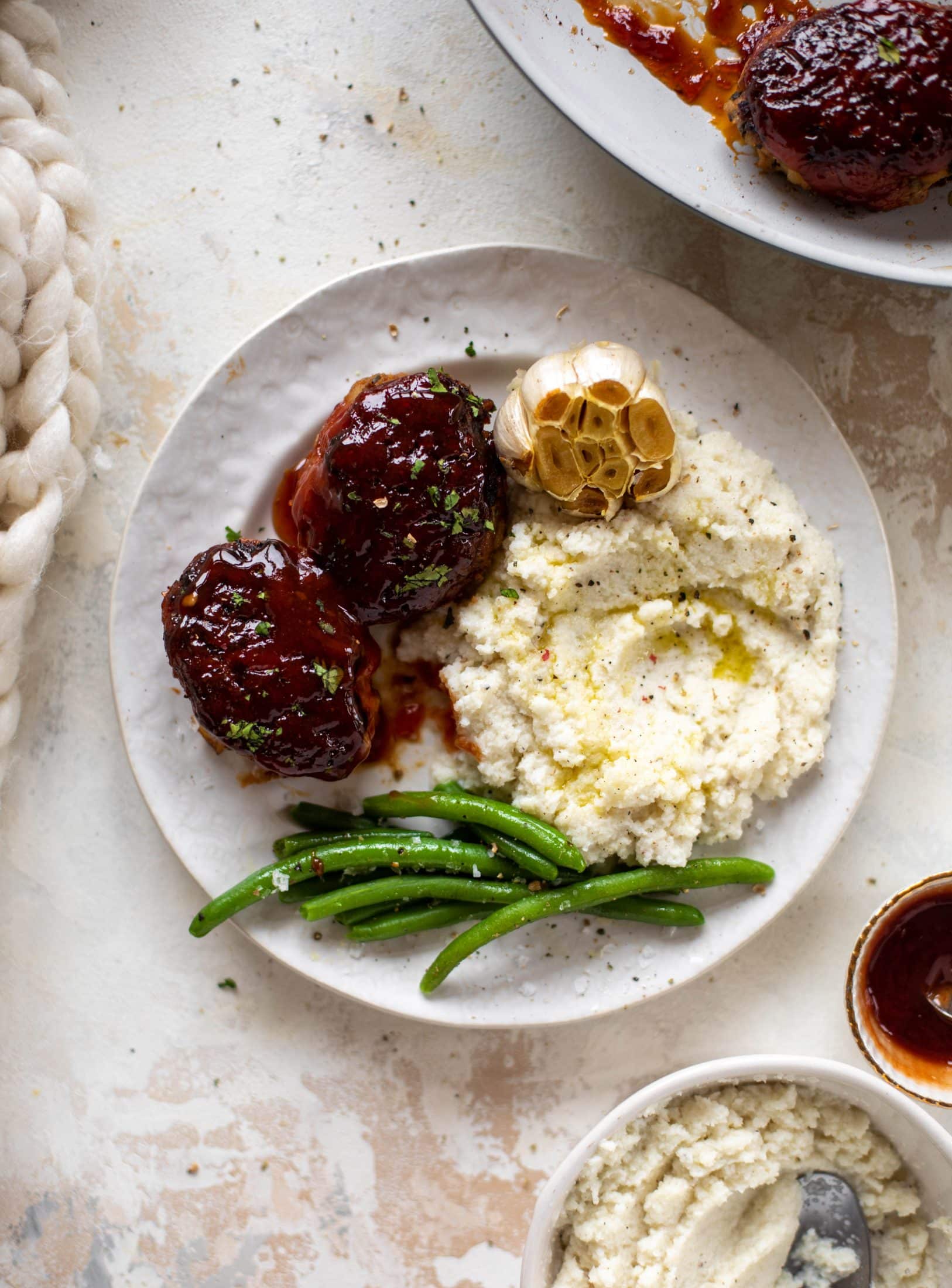 Mini turkey meatloaf in a skillet is the best weeknight dinner idea! Serve with roasted garlic cauliflower mash and your favorite green veggie on the side.