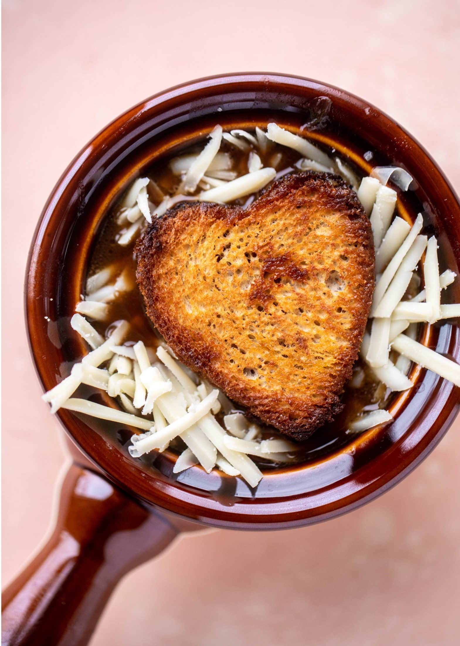My favorite french onion soup starts with bourbon caramelized onions! Adorable heart croutons and tons of gruyere take it over the top.