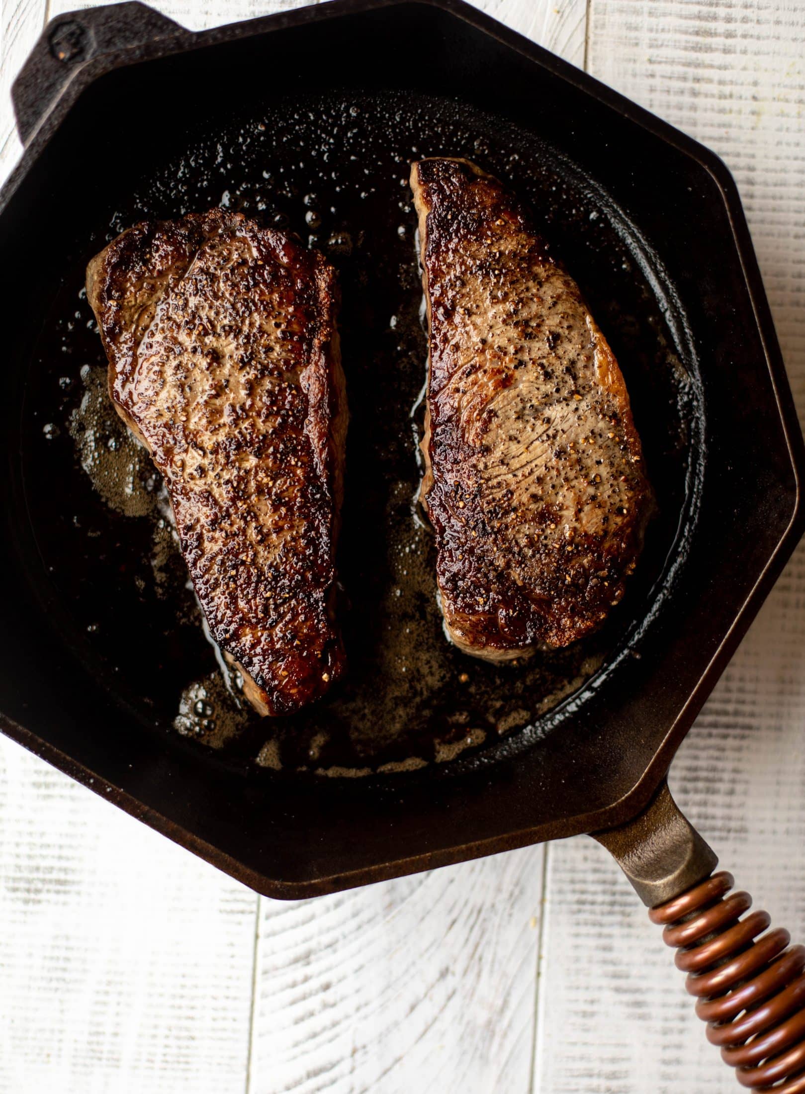 This is our favorite steak frites! Seared skillet steak and crispy fries made in the air fryer, topped with truffle salt, parmesan and herbs!