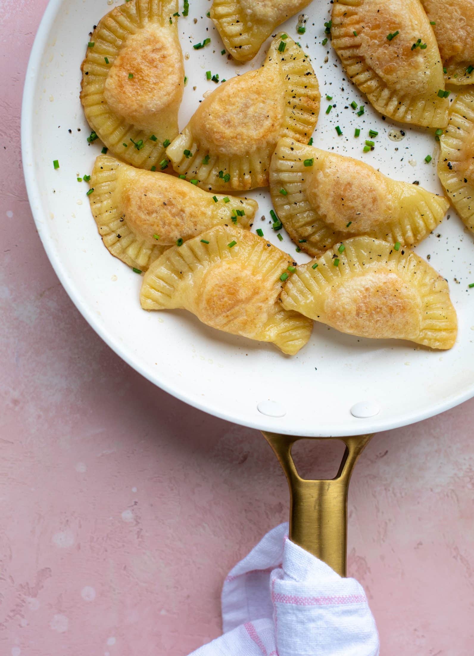 The most delicious sweet potato pierogi recipe! Roasted sweet potato and fontina cheese in pillowy dough. Make sure to serve with brown butter!