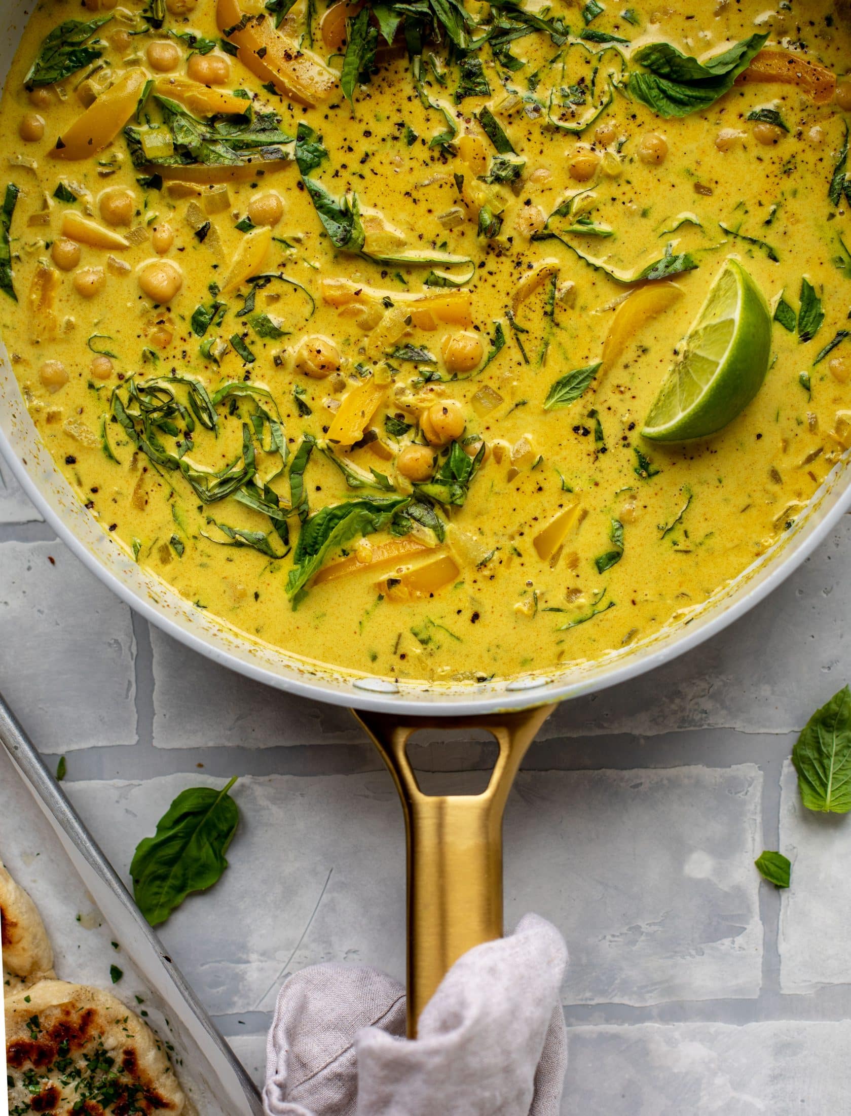 This basil chickpea coconut curry comes together in 20 minutes! Serve with jasmine rice or your favorite naan, or both! So easy and flavorful.