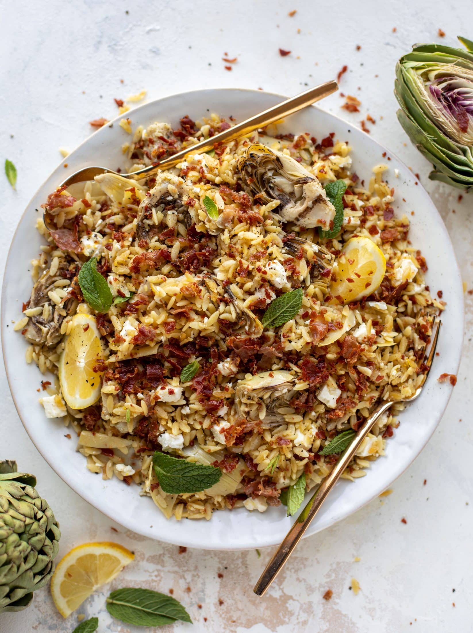 This crispy orzo is a wonderful spring dish. Artichoke hearts, lemon, goat cheese and herbs all topped with a sprinkling of crunchy prosciutto.